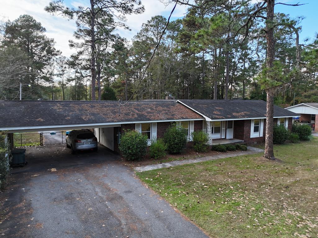 Charming 1975 home situated on 1.5 acres featuring 3 bedrooms and 3 full baths. Interior highlights include oak wood flooring (under carpet) throughout the main part of the home and a nice kitchen equipped with a 6-burner gas cooktop, new oven, dishwasher, and refrigerator. A large laundry room with a utility sink and room for a freezer plus storage. Generously sized bedrooms and functional layout offer comfortable living. A large addition includes a living area with brick fireplace, gas logs, and wainscotting. The large private lot provides ample outdoor space for gardening, and recreation. Convenient location with a blend of privacy and accessibility. Move-in ready with room to personalize. This home has so much to offer! Make an appointment today!!
