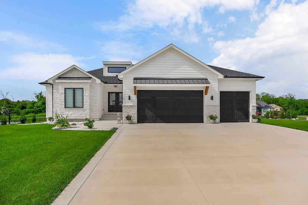Welcome home to this like-new beauty in the highly sought-after Lake Winnebago community. The inviting Great Room features a cozy gas-log fireplace with floating shelves, tinted windows, custom shades, and updated designer lighting. The kitchen is truly the heart of the home, showcasing newer 2024 appliances, quartz countertops, a walk-in pantry, and an open dining area with hardwood floors, custom blinds, and an elegant tray ceiling. The primary suite is a serene retreat with a shiplap ceiling, crown molding, custom blinds, and a thoughtfully designed walk-in closet with pull-downs. The spa-inspired primary bath offers double granite vanities, a whirlpool tub, shiplap accents, and a beautifully tiled walk-in shower. Just off the primary closet, the laundry room blends function and style with built-ins, granite countertops, tile flooring, and a sink. Two generously sized upstairs bedrooms share a stylish hall bath with granite countertops, luxury vinyl plank flooring, and a tiled shower. The finished lower level adds even more living space with a curved staircase, a spacious rec room featuring LVP floors, floating shelves, and granite counters, plus a true fourth bedroom with a walk-in closet and oversized windows for abundant natural light. Widened doorways and ADA-compliant toilets provide added accessibility throughout, along with dual-zoned HVAC for comfort and efficiency. Enjoy outdoor living on the covered Trex deck with ceiling fan, overlooking a spacious corner lot backing to peaceful greenspace. Newer 50-year roof! All of this comes with access to Lake Winnebago’s premier amenities, including boating, trails, pickleball courts, equestrian facilities, a play area, and exciting community events—with a pool and clubhouse coming soon.