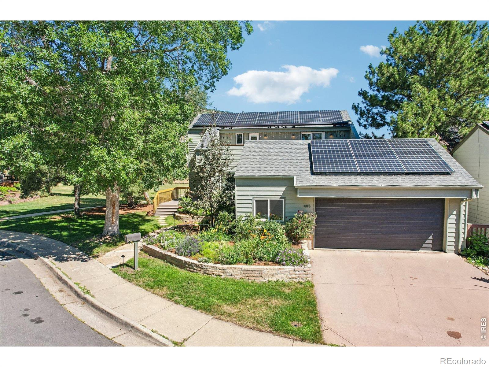 Get Ready for Something Exciting, Get Ready for 405 Oakwood Pl. in desirable Wonderland Hills. This 5 BR, 5 BA home tucked at the end of a quiet cul-de-sac, overlooking neighborhood park, saltwater pool and tennis/pickleball courts while sitting adjacent to some of Boulder's best trails is the ideal spot for your active Colorado Lifestyle. The inviting foyer with built in shelving and hooks begs you to kick off your shoes and stay a while. Gorgeous real wood floors welcome you to a fun and functional floorplan with a family room offering tons of glass to bring the outside in, fresh paint and brand new carpeting that flows seamlessly to the formal dining room and kitchen with newer appliances, gorgeous lighting and soulful finishes. The rich wood ship-lap lined formal living room with soaring ceilings boasts a gas fireplace wrapped in mossrock with spectacular mountain views over HOA common space. Additionally, the main level offers a charming bedroom with its own designer created en-suite full bath. And there's even a stunning powder room on the main level perfect for guests. Upstairs you'll find two large bedrooms, each with their own magazine worthy bathrooms and access to private decks. The primary suite is massive and offers an enormous private deck complete with hot tub! Venture to the daylight basement where you'll find room for everyone to spread out with an additional rec room, remodeled bath and two generously sized BRs along with a true laundry room and large storage area... NICE! With an owned 10.5 kW PV system, a furnace and ac for the main level and a heat pump with air handler for upstairs this home offers that efficient sanctuary with year round comfort that you've been seeking. With highly ranked schools, coveted amenities, access to trails and shopping at the neighborhood Lucky's center and an absolutely stunning home, it's hard to imagine a better spot. Let's Get You Home!