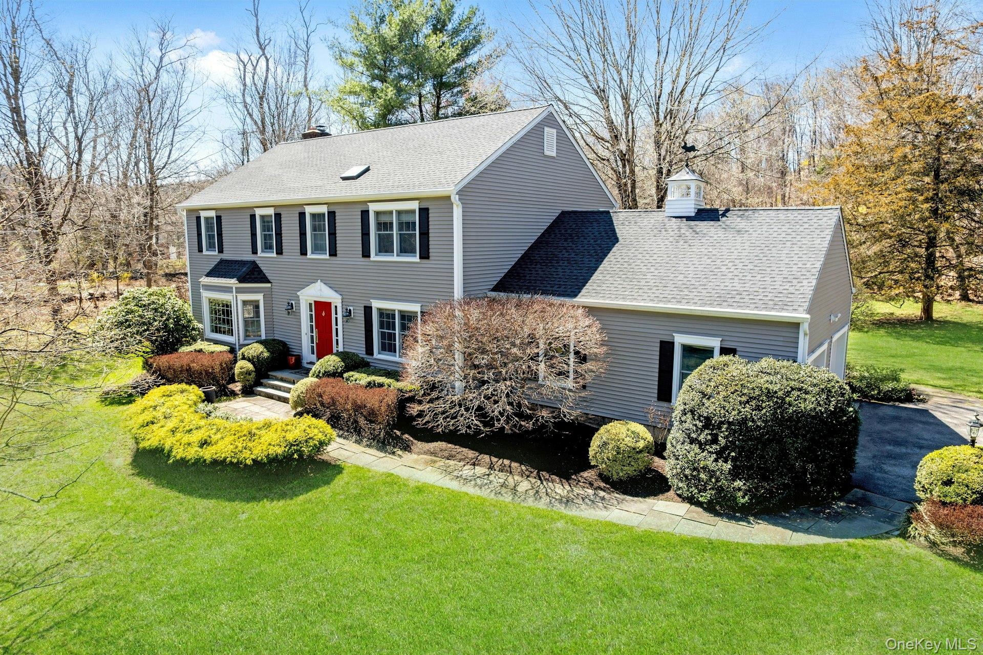 A Modern Colonial Retreat, 83 Upper Shad Road, is situated on 2.25 private, level acres in the heart of Pound Ridge.  Mature trees and professionally designed landscaping create a serene, park-like environment, with an in-ground pool and manicured green expanses that surround the home. (Did I forget to mention the babbling brook at the corner of the property?)   The home features a primary bedroom suite plus 2 additional, generously sized bedrooms, 3.5 bathrooms, living room, den, formal dining room and kitchen with center island. The finished lower level adds an open-plan living area with a large office, library, entertainment center, and full bath.  The heart of the home is a breathtaking living room featuring double-height, vaulted ceilings and classic wood-burning fireplace. French doors open to the patio dining area and offer clear views of the private backyard and sparkling heated pool.  Adjacent to the living room, a separate den and large dining room open onto each other, making the space perfect when hosting large gatherings. The Chef’s kitchen features a large central island and abundant cabinets with room for a cozy breakfast nook. The formal dining room adjoins the kitchen, while the kitchen backdoor flows directly onto a private deck--an ideal BBQ space overlooking the pool and gardens. Just beyond the deck is a large stone patio perfect for seasonal dinners. The gated sparkling gunite pool and expansive deck area are flanked by lush flowering landscaping including magnificent rhododendron, Japanese maples, hydrangeas, and an array of colorful flowering plantings. A cedar shed, an attached 2-car garage and Invisible fencing help keep your cars and tools snow-free and your pets secure. The total square footage of the home includes the large finished lower level. The location offers exceptional convenience, just minutes from shopping and dining in Pound Ridge, Bedford, New Canaan, Stamford and Ridgefield. Commuters will appreciate the easy access to the Merritt Parkway and I-684, as well as the nearby Metro-North stations.