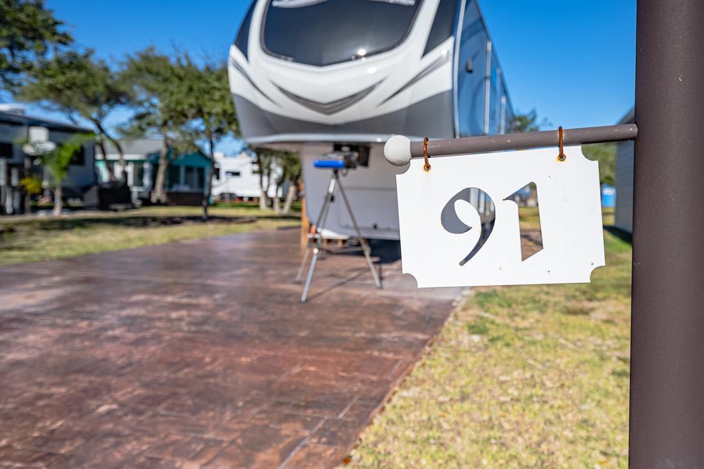 Discover a premier RV lifestyle in this gated community, offering ultimate RV hookups and the opportunity to build your dream casita. This property is located on an interior lot shaded by beautiful trees, providing a serene setting and added privacy. The lot features a concrete RV pad with hookups. The HOA provides an array of luxury amenities, including a recreational center and clubhouse for social gatherings, a heated saltwater pool with a brand-new spa, coin-operated laundry facilities, a fully equipped fitness center, a dog park, walking trails, a pickleball court, and stocked ponds for catch-and-release fishing and daily trash pickup.  With a 30-day minimum for long-term rentals, this property is also a fantastic investment opportunity.  Embrace this one-of-a-kind RV resort lifestyle—your perfect getaway awaits! Please note: RV is sold separately.
