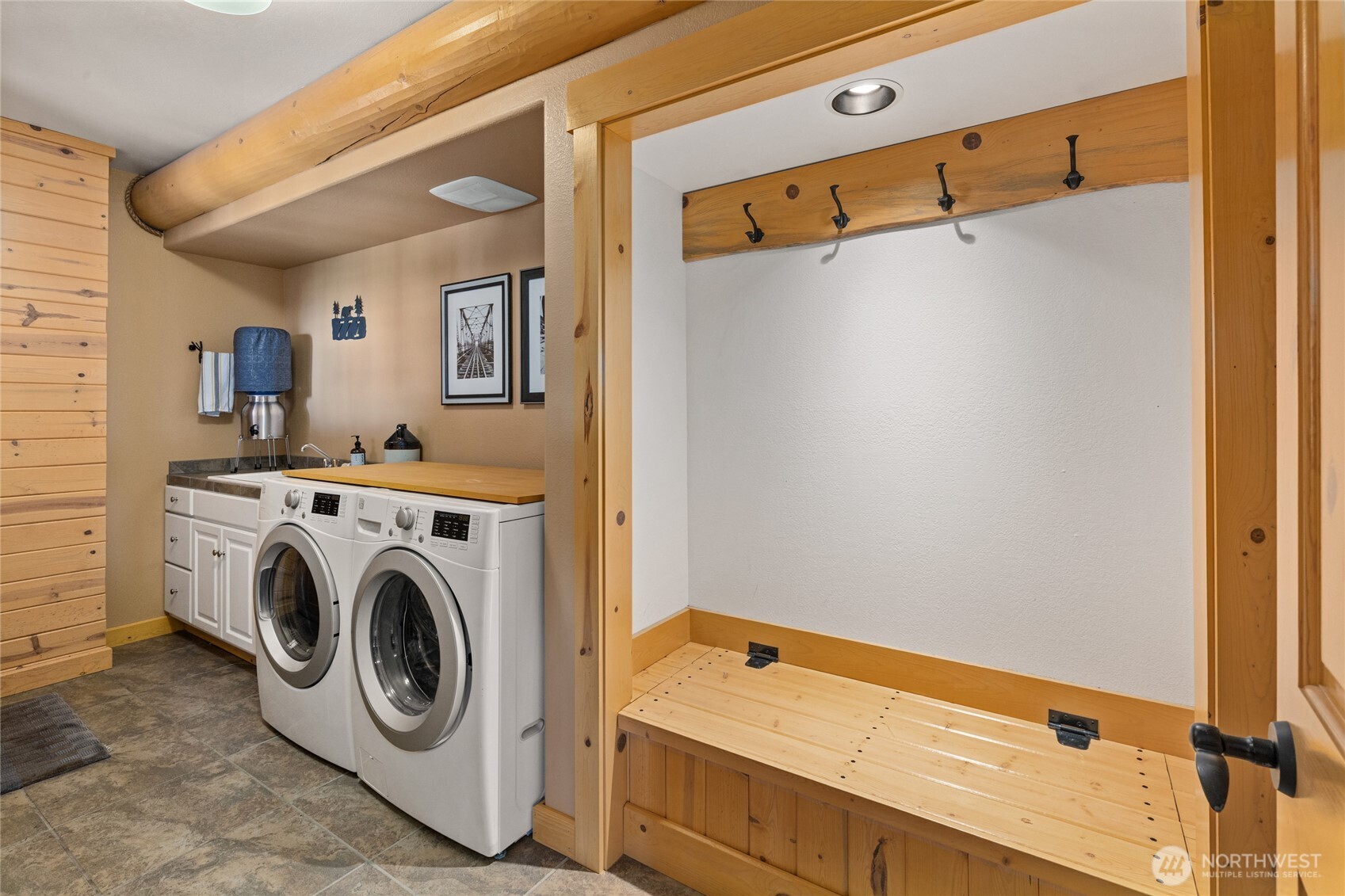 Dedicated laundry and mudroom with utility sink, built-in bench, storage, and convenient space for everyday gear.