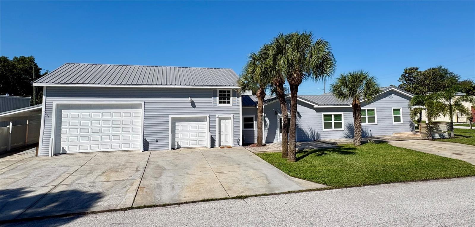 Welcome to this fully remodeled home situated in a B1 commercial zone, centrally located in Pinellas Park. Bring your cars, your workshop or run your entire business out of this home. The garage offers 1192 sq ft, four bay doors, three levels of storage, its own bedroom equipped with a mini split, and a bathroom. This home offers seven parking spots with two separate driveways, not including the carport and the garage. Inside the house you will find a split floor plan including an oversized primary bedroom with an ensuite bathroom, and its own mini split to control the temperature exclusively in the primary bedroom. On the other side of the house, you will find two bedrooms with walk in closets and a remodeled bathroom. There is tile throughout the entire house, including the garage bedroom and bathroom. This home has been lovingly cared for and fully remodeled with black granite on white shaker cabinets and crown molding throughout. The windows are hurricane impact rated and encased in wood. The roof is metal on the house and the garage. A brand new electrical panel was installed this year, the main AC was replaced in 2018, and the hot water heater was replaced in 2021. The kitchen appliances were updated three years ago with top rated Samsung black stainless steel, including a stove with a built-in air fryer and a dishwasher that you can’t hear running. Lastly, the washer and dryer are located in the house! It is ready for a family that needs a living space separate from the house, a business that needs a workshop, or an investor who sees the potential of owning B1 commercial in the heart of Pinellas Park.