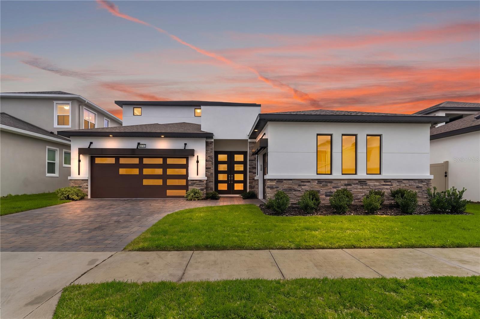 Contemporary luxury, exceptional custom enhancements, and a private pool courtyard come together at 10782 Torchwood Sea Way in Eagles Cove at Mirada. Completed in 2025, this DRB Homes Osprey 3 residence features 3,188 square feet of heated living space and 4,714 total square feet, with five bedrooms, including one transformed into an EXPANSIVE CUSTOM PRIMARY CLOSET, three full bathrooms, and one upgraded half bathroom. Premium builder upgrades and custom additions create a distinctive home within Mirada’s lagoon community. Upgraded privacy glass double doors introduce an interior accented by additional windows, decorative tray ceilings, custom lighting, and carefully selected finishes. The open kitchen, dining, and living areas flow effortlessly together, creating generous spaces for everyday living and entertaining. Gas cooking, an installed pot filler, a wall oven, and a spacious kitchen island combine functionality with contemporary style. A CUSTOM BUILT TV ACCENT WALL anchors the living room with a dramatic focal point, while a large center opening sliding glass door connects the interior to the courtyard. CUSTOM FITTED BLINDS AND ROLLER SHADES by Tampa Window Shades bring a coordinated finish throughout, with motorized shades at select primary bedroom and living room openings for added convenience. CUSTOM LIGHTING enhances the architectural details. The first floor primary suite creates a peaceful escape with an indulgent wet bath featuring an oversized shower area, enlarged glass enclosure, two independently controlled shower heads, recessed niches, and a freestanding soaking tub. One bedroom has been transformed into an expansive CUSTOM PRIMARY CLOSET by Closets by Design, with professionally designed storage and organization that brings a boutique inspired experience into daily life. Upstairs, a spacious bonus room provides flexibility for a media lounge, game room, second living area, or creative retreat. The covered balcony creates another inviting setting for relaxation, with sliding glass access from the bonus room and two upstairs bedrooms. Your private HEATED SALT WATER POOL AND SPA take center stage in the courtyard, complemented by a screened lanai and covered pool cabana with an installed Paradise Grills OUTDOOR KITCHEN. Premium Pentair pool equipment and a HeatWave SuperQuiet heater complete this outdoor retreat. From sunny afternoons poolside to alfresco dinners and evenings in the spa, this space makes staying home feel like a getaway. A THREE CAR GARAGE configuration, with a two car garage on one side and a separate single car garage on the other, provides room for vehicles, storage, and hobbies. Upgraded coated floors complete both garages. Mirada’s approximately 15 acre lagoon brings a beach inspired experience into the community. Clear blue water, sandy shorelines, swimming, kayaking, and paddle boarding create a setting for recreation and relaxation. Water attractions, cabana rentals, waterfront bars, and resident activities add to the experience, with walking trails, playgrounds, a dog park, tennis, pickleball, and ULTRAFi connectivity enhancing the community lifestyle. With its custom primary closet, statement accent wall, custom blinds and lighting, private pool oasis, and signature Mirada setting, this residence brings together the details that make luxury living feel personal. Schedule your private showing today.