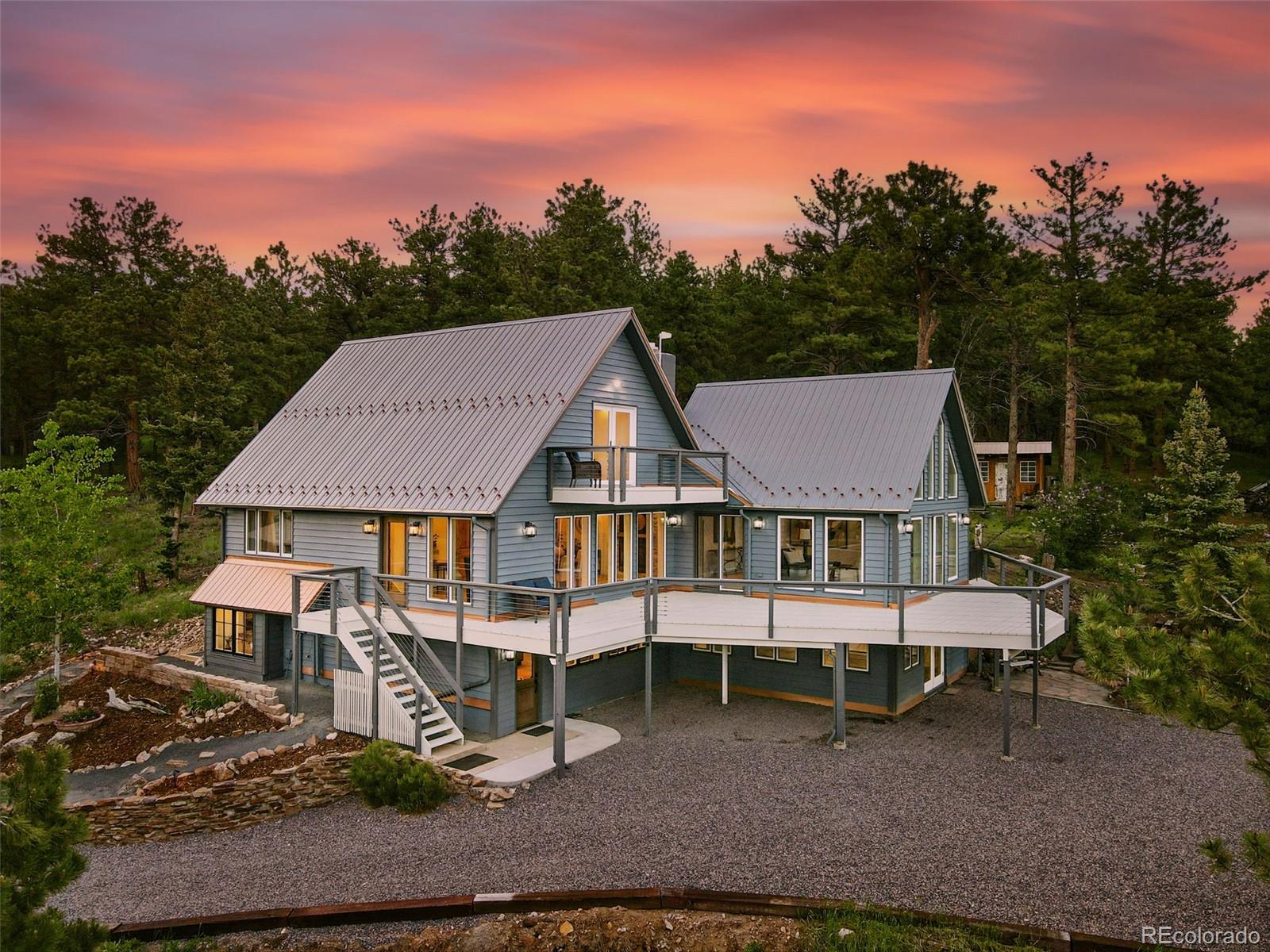 A True Mountain Retreat. This rare opportunity offers a stunning mountain property with both seclusion and convenience-just minutes from downtown Boulder, yet immersed in nature with expansive 360-degree views near national forest. Extensively and thoughtfully remodeled, the home features high-efficiency appliances, updated double-pane wood casement windows, and new doors for improved energy performance. A durable metal roof insulated to R48 ensures year-round comfort. The electric radiant ceiling heat system provides dust-free warmth with zoned smart thermostats in every room—designed to feel like sunlight on a warm day. A sunroom just off the main living area showcases some of the home’s most spectacular views. Bathed in natural light, it opens to the deck—perfect for morning coffee, sunset watching, or quiet reflection. Though listed as a 3-bedroom due to septic rating, a flexible 4th room offers options for a bedroom, office, or creative space, complete with upper-level laundry hookups. A lower-level mother-in-law suite with its own kitchen and laundry makes this home ideal for multigenerational living, shared ownership, or rental flexibility—with two full kitchens and two laundry areas offering exceptional versatility. You’ll also find a spacious lower-level bonus room—perfect for a home gym, craft studio, or workspace. Just off the kitchen, a beautiful flagstone patio expands your living space outdoors, surrounded by professionally designed mountain landscaping and anchored by a gas firepit—an inviting setting for gatherings or quiet evenings under the stars. Multiple outbuildings, including a detached workshop, add even more functionality. Fire mitigation certification is in place. Friendly neighborhood with a strong sense of community. Wildlife abounds—deer, foxes, birds, and more. If you’re seeking a mountain lifestyle with easy access to Boulder, this is the one. Peaceful. Private. Connected. Welcome home.