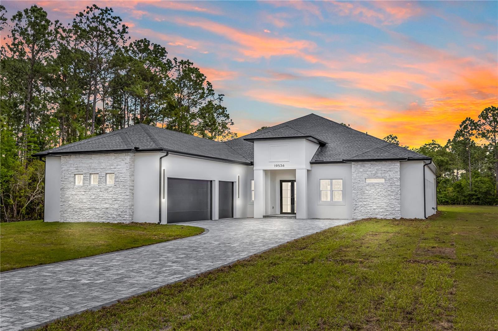 SELLER OFFERING CREDIT TOWARDS A POOL WITH AN ACCEPTED OFFER. WOW does not even begin to cover it. BRAND NEW CONSTRUCTION sitting on 1.03 DRY ACRES in the sought-after Wedgefield community, packed with jaw-dropping finishes you have to pinch yourself to believe. This is not your average new build. This is magazine-worthy living at its absolute finest. From the moment you pull up, that ELEVATED DOUBLE FRONT DOOR WITH GLASS makes a statement. Step inside and you will immediately notice the SOARING HIGH CEILINGS, LVP FLOORING THROUGHOUT, and ENERGY-EFFICIENT PGT HURRICANE IMPACT WINDOWS.... this home was built to impress from the inside out. Oh, and did we mention the 3-CAR GARAGE? Now let's talk about that KITCHEN. TALL CEILINGS WITH STUNNING FAUX WOOD BEAMS, jaw-dropping FORNO BLACK APPLIANCES, OVEN-MICROWAVE COMBO, STACKED CABINETRY, THICK-SLAB QUARTZ ISLAND, and a WALK-IN PANTRY. This kitchen does not just cook....it performs. The FORMAL DINING ROOM flows right into a spacious living area that opens through SLIDING GLASS DOORS onto a COVERED PATIO WITH WOOD CEILING FEATURE and an EXPANSIVE DECORATIVE PAVER PATIO. You are going to live outside on this patio. Every bathroom in this home features FLOOR-TO-CEILING DECORATIVE LUXURY TILE. The master suite is pure pinch-yourself luxury with HIS AND HER WALK-IN CLOSETS, a FREESTANDING SOAKING TUB, DOUBLE VANITY, LINEN CLOSET, and a WALK-IN SHOWER that belongs in a five-star resort. The JACK-AND-JILL BATH is the perfect space and one bedroom has its own PRIVATE EN-SUITE WITH DIRECT PATIO ACCESS. A DOUBLE-DOOR OFFICE/BONUS ROOM rounds it all out. Additional highlights include CUSTOM BUILT-IN CLOSETS in every secondary bedroom, a fully appointed INDOOR LAUNDRY ROOM with washer, dryer, wash tub, countertop and cabinets, and HIGH CEILINGS throughout every single room. Wedgefield puts you 20 minutes to Orlando International Airport, 30 minutes to downtown Orlando, and 40 minutes to the Space Coast — peaceful acreage living with unbeatable access to all Central Florida has to offer. No detail was missed. No corner was cut. BRAND NEW CONSTRUCTION. MOVE-IN READY. Come see it before someone else pinches themselves on YOUR dream home.