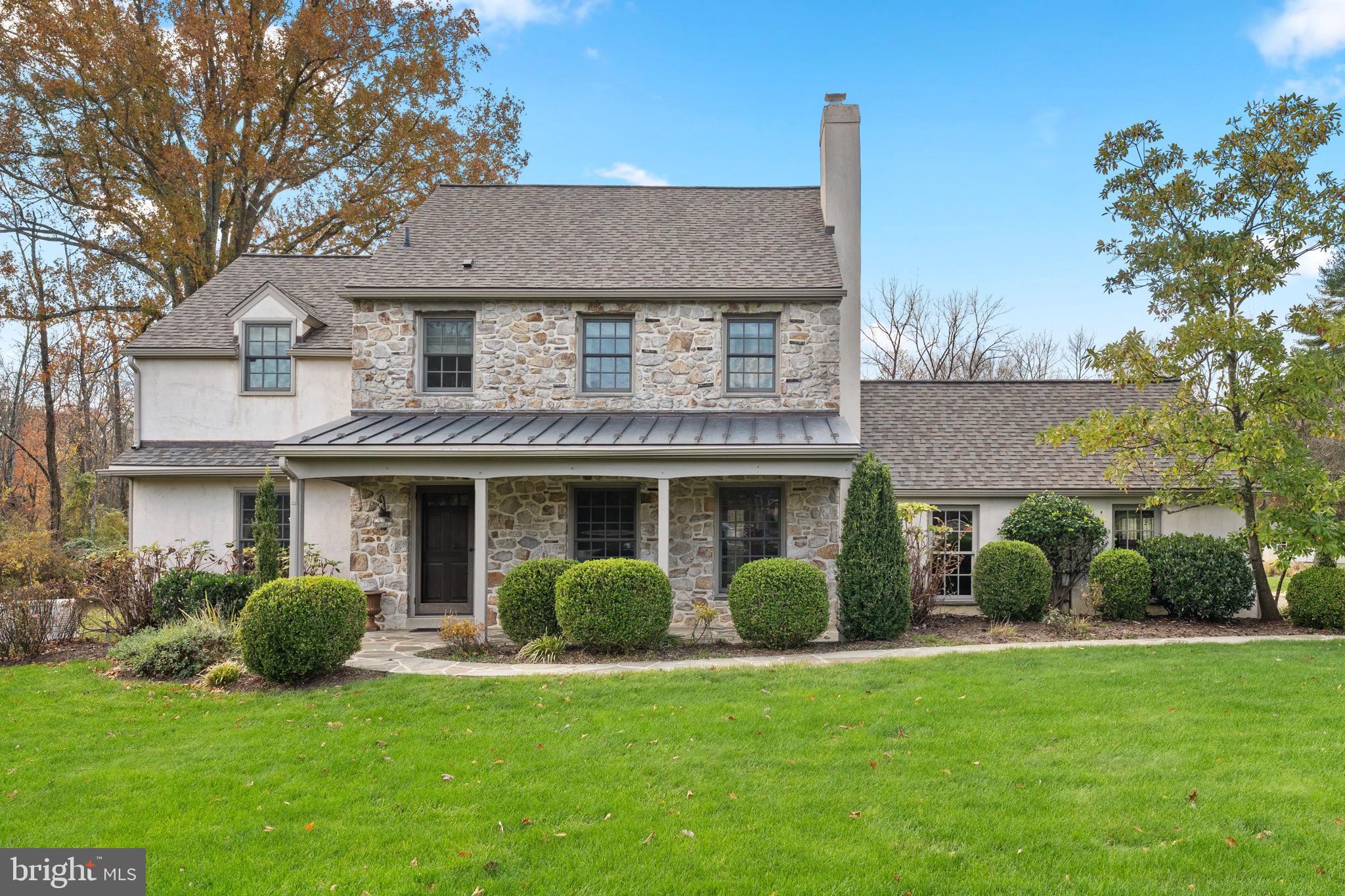 This beautiful colonial, ideally located on a quiet cul-de-sac sits on a 1.5 level acre lot, backs up to 15 acres of protected wooded open space and is in the award winning Tredyffrin-Easttown School District.  The classic stone front and covered porch pay homage to historical Chester County farmhouses.  Walk up the flagstone walkway flanked by mature boxwoods and perennials and step inside a home with plenty of room for entertaining whether it be formal or casual.  Hardwood floors extend throughout the first floor providing a warm and inviting atmosphere. On your right is the living room with two built-in corner cabinets on either side of a wood burning fireplace and to the left is a formal dining room, both rooms have easy access to the kitchen allowing for easy entertaining. The kitchen boasts a large island, granite countertops, double ovens, tile backsplash, stainless steel appliances, farmhouse sinks and vaulted ceiling. French doors in the ample eating area provide plenty of sunlight and access to the patio. The large family room off the kitchen has a wood burning fireplace, custom built-ins and a window seat that spans the length of the room overlooking the back yard. The laundry room and a half bath can also be found on the first floor. Upstairs all four bedrooms have hardwood floors and plenty of light and closet space. The updated hall bath has a tub/shower and an oversized single vanity with plenty of storage plus a linen closet for sheets and towels. The primary bedroom has two spacious closets and a bathroom with a single vanity and step-in shower with tile surround. The third floor offers a great opportunity for a private home office, playroom or guest room. The house offers plenty of storage space, on the third floor, in the basement and in the 2-car garage.  A generator is a there to ensure you never lose power. The expansive backyard is big enough for a pool, a tennis court and a swing set! Close to Paoli, Berwyn and Wayne shopping and restaurants.
