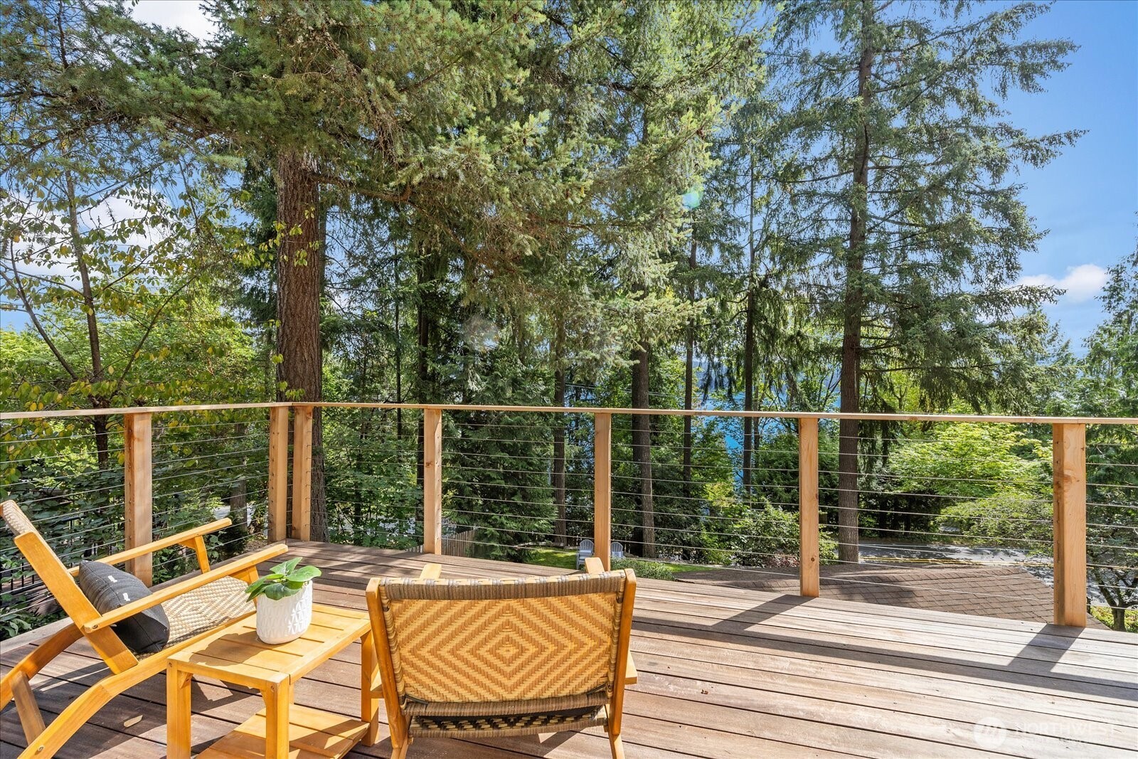 Tucked into a peaceful, private setting surrounded by Northwest greenery, this light-filled West Lake Sammamish home offers exceptional space inside & out. Fully remodeled in 2018 and move in ready!Three bedrooms upstairs include a standout primary retreat with a dramatic wall of windows framing the natural surroundings & a private balcony. A bonus area provides additional space to lounge, while a 4th bedroom on the main easily doubles as a home office or guest suite.    The backyard is where this property really shines. An oversized deck & several outdoor gathering areas invite dining, entertaining or relaxing. Enjoy movies under the stars, shoot hoops on the sport court or head to the treehouse. Direct access to the trails of Weona Park makes it easy to step outside & explore. A sunny front lawn with raised garden beds is ideal for enjoying the morning sun.    A detached garage with EV charger adds everyday convenience. Ideally located near Lake Sammamish, parks, trails, 520 or I90, with highly regarded Bellevue schools. A rare combination of privacy, versatility, incredible outdoor spaces & direct access to nature. New interior paint, carpet, water heater, and stove.