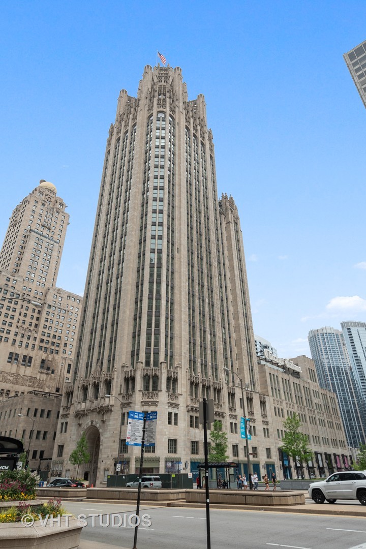 Experience the pinnacle of luxury living in this breathtaking 2,900 SQFT, 3-bedroom, 3.1-bath residence at the iconic Tribune Tower. Designed with impeccable attention to detail, this home seamlessly blends classic elegance with modern sophistication. A grand foyer, ideal for displaying an art collection, leads to a masterfully crafted floor plan adorned with intricate crown molding, soaring 12-foot ceilings, and wide-plank white oak hardwood floors.    Expansive, elongated windows frame striking neo-Gothic architectural details while offering unobstructed south and west views of the private park, Chicago River, and skyline. The generously proportioned living space is designed for both refined entertaining and everyday comfort, featuring a stately marble fireplace, a bespoke entertainment center, and an elegant dining area with awe-inspiring river views.    The chef's kitchen is a masterpiece, boasting quartzite countertops, an oversized island, white Shaker cabinetry, a wine refrigerator, and the finest appliances, including a Wolf range/oven, Sub-Zero refrigerator/freezer, and two Miele dishwashers.    Retreat to the lavish primary suite, where city skyline views set the stage for relaxation. A custom walk-in closet complements the spa-inspired ensuite bath, a sanctuary wrapped in white marble with intricate inlays, heated floors, a dual vanity, freestanding soaking tub, and an oversized glass-enclosed shower. Two additional ensuite bedrooms echo the same level of refinement with luxurious finishes.    Every detail of this residence has been thoughtfully curated, from $50K in custom closet designs to remote-controlled light-filtering and blackout blinds, designer chandeliers, sconces, imported tile accent walls, and exquisite accent wallpaper.    Residents of the Tribune Tower enjoy world-class amenities, including a spectacular 75' indoor/outdoor pool, an expansive sun deck with Wolf appliances, a state-of-the-art fitness center, a golf simulator, private meeting rooms, a game room with billiards and board games, and two catering kitchens featuring Wolf and Sub-Zero appliances-perfect for hosting extraordinary events. Elevate your lifestyle with exclusive access to "The Crown" on the 25th floor, where a breathtaking 360-degree panorama of Chicago unfolds.    This exceptional home includes three premium adjacent parking spaces-one equipped with an electric car charger-and two additional storage units, available for $195K.    Indulge in the extraordinary. Schedule your private viewing today.