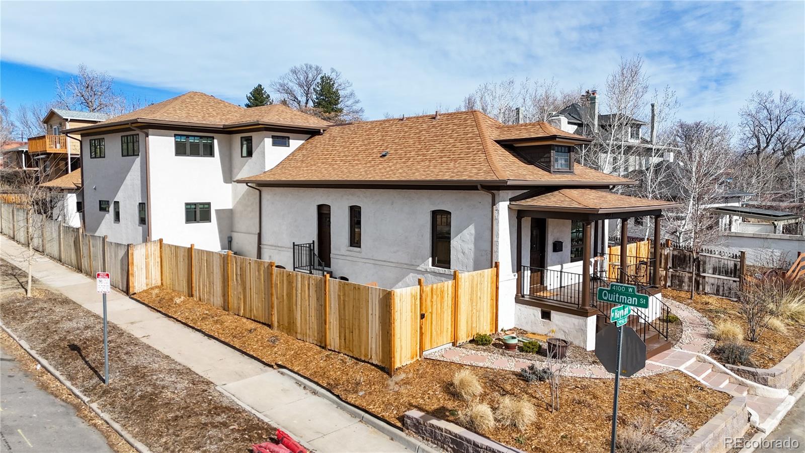 Set on a prominent corner lot in the heart of the West Highlands, this exceptional property pairs timeless character with a stunning modern expansion. Extensively renovated and thoughtfully reimagined, the residence offers updated systems, generous scale, and a layout designed to support both privacy and effortless gathering.The original portion of the home retains its charm, featuring inviting living and dining spaces, a wood-burning fireplace, and two multi- purpose rooms connected by a Jack-and-Jill layout. The newly completed addition introduces a dramatic main living room, a ground-floor primary suite, ample storage throughout, and, upstairs, two additional large bedrooms with a full bath.The finished basement adds even more versatility, with a bathroom, utility area, and a private-entry suite ideal for visitors or potential rental opportunities.Outdoor living is a true highlight. A welcoming front porch, expansive patios, and a spacious, fully fenced yard create multiple settings for relaxing or entertaining. The two car detached garage provides the ultimate convenience with access via an automatic gate and electric wiring for workshop, studio or EV use.West Highlands remains one of Denver’s most coveted neighborhoods, known for its leafy streets and easy access to Highlands Square, Tennyson Street, Sloan’s Lake, and a vibrant mix of dining, boutiques, and cultural destinations. Downtown and major commuter routes are only minutes away.This is a move-in-ready property where classic architecture meets modern livability, offering space, style, and exceptional flexibility in a premier location.