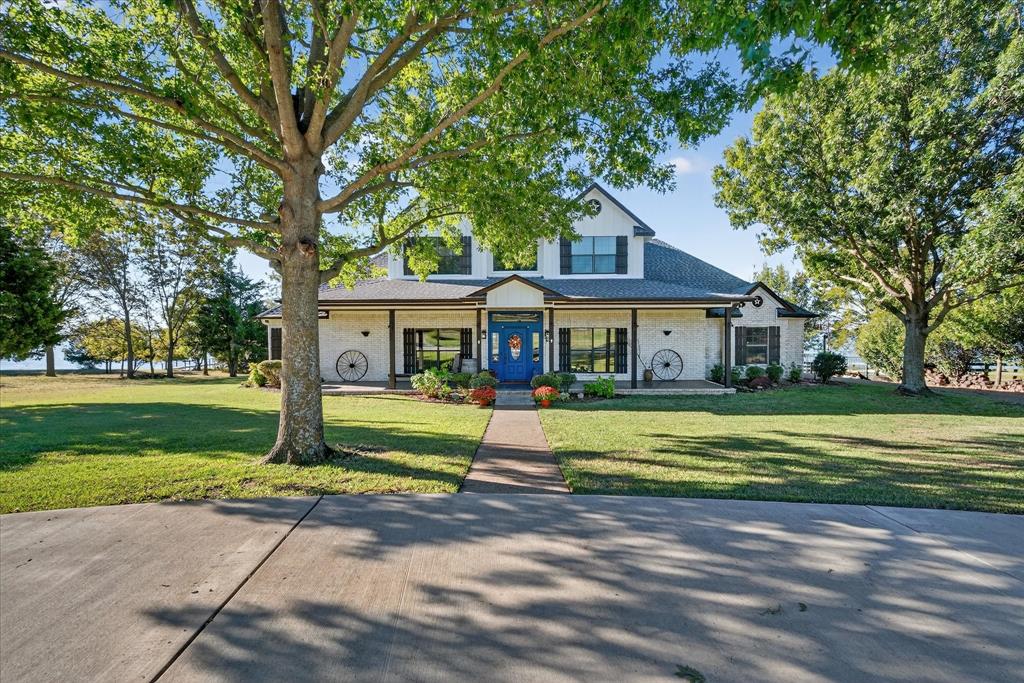 Experience lakefront living at its finest with this gorgeous 4-bedroom, 2.5-bathroom home on Richland Chambers Lake! Nestled in the desirable Arrowhead subdivision, this property offers breathtaking views from every room. The vaulted great room has floor to ceiling windows with an open-concept setting.  The dining area flows seamlessly into the spacious kitchen, creating the perfect setting for gatherings and entertaining with a view. The primary suite on the first floor offers both comfort and luxury with an ensuite bathroom featuring a garden tub, separate shower, and dual sinks. A half bath on the main level provides extra convenience for guests. Upstairs, you’ll find three additional bedrooms and full bathroom— each with amazing lake views — offering plenty of space for family or visitors. Enjoy outdoor living year-round with a large covered porch featuring a full outdoor kitchen, ideal for relaxing or hosting family and friends. The bricked backyard area with a custom fire pit provides a cozy spot to unwind as you take in the sunset over the water. A private boathouse allows easy access to the lake for fishing, boating, or simply soaking in the serenity. Fenced backyard is perfect for pets or kids to play safely. Whether you’re looking for a weekend retreat or a forever home, this breathtaking waterfront property is a rare opportunity to live the lake life you’ve always dreamed of.