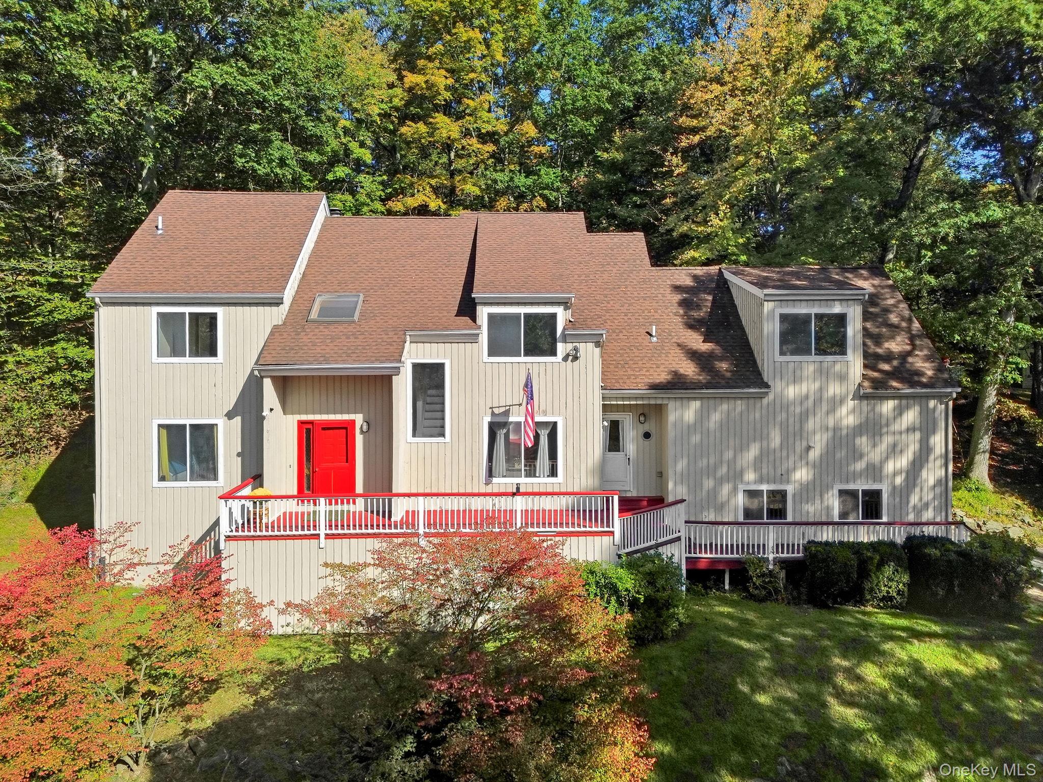 Experience the ultimate blend of sophistication and serenity in this striking contemporary retreat set up high in sought-after North Salem. Set on 1.49 acres of lush, wooded privacy in the exclusive Lake Hawthorne community, this 4-bedroom, 2.5-bath residence spans over 2,700 sq ft of beautifully designed living space.  Soaring vaulted ceilings, skylight, and walls of windows bathe the home in natural light, while a grand brick fireplace and wet bar create a chic backdrop for both intimate evenings and lively gatherings. The open, airy flow extends seamlessly to expansive front and back decks—perfect for al fresco dining, summer entertaining, or simply soaking in the tranquil, tree-lined setting.  Inside, wood floors, spacious rooms, and refined details set the tone for effortless elegance. Modern comforts include central air, a brand-new hot water heater, and a 2-car garage. With just a little TLC this house can become the potential you are looking for in this great location and property.  Every detail has been crafted to offer a lifestyle of peace, privacy, and convenience—just minutes from town, schools, highways, horse riding, farmer markets, fruit farms and all that North Salem has to offer.  This is more than a home—it’s a private sanctuary, where nature and style meet in perfect harmony.  Lake Hawthorne host many events throughout the year at the lake including 4th of July BBQ, Bonfire and S'mores beach party, Ice Skating on the lake, and block parties.  There is such much to do here in North Salem NY.