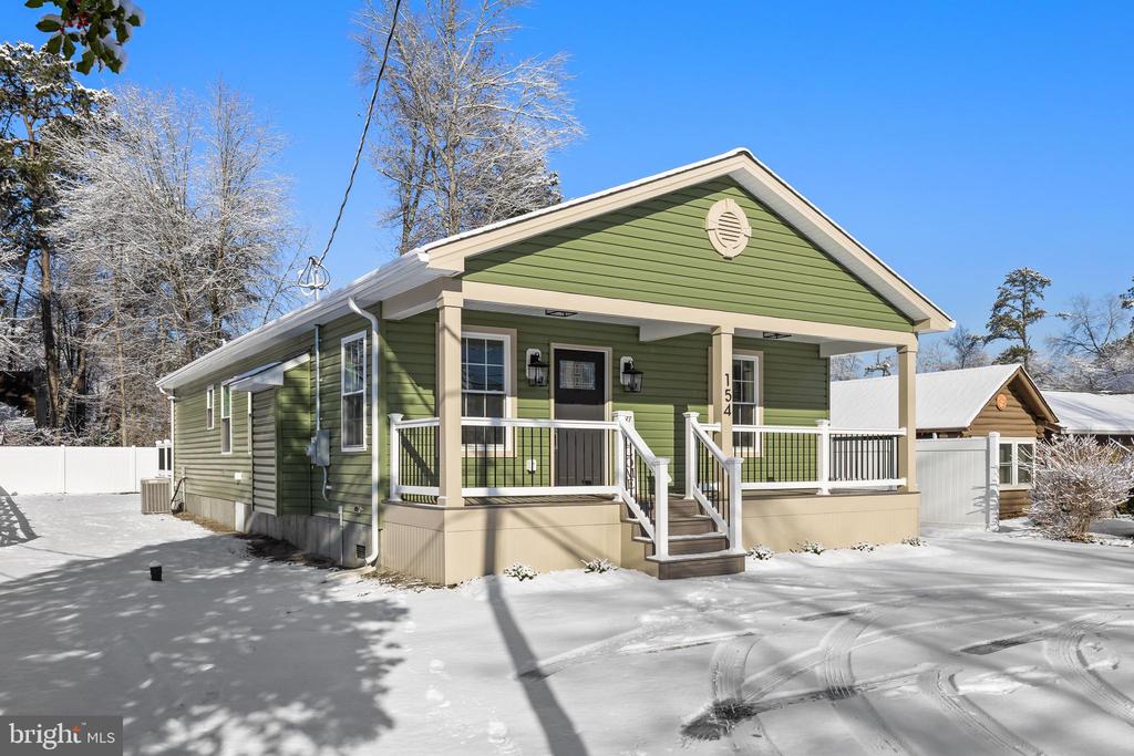 Rare, Brand-New Construction in the Lake Pine CommunityWelcome to a truly exceptional opportunity where modern, energy-efficient luxury meets lakeside serenity. This newly constructed home in the coveted Lake Pine community is thoughtfully designed, impeccably finished, and ready to impress.From the moment you arrive, the circular driveway with natural stone accents makes a striking first impression. A sprawling covered front porch, finished with premium tree-type decking and designer lighting, invites you inside through a charming cottage-style entry door.Step into a light-filled, open-concept living space underscored by vinyl plank flooring and crowned by soaring cathedral ceilings that create a warm yet dramatic central gathering area. A sleek, modern fireplace, activated with the touch of a remote, adds both ambiance and comfort, while the expansive dining area easily accommodates entertaining on any scale.The kitchen is a showstopper, blending form and function with ease. Highlights include quartz countertops, high-end appliances, a custom ceramic backsplash, in-counter disposal switch, dedicated trash and recycling drawer, and custom cabinetry with soft-close hardware throughout. A generous breakfast bar seats five, complemented by a large pantry and adjacent laundry/mechanical room with brand new washer & dryer that complete this wing of the home.The private bedroom wing is a peaceful retreat. The primary suite features a spacious walk-in closet and a spa-inspired en-suite bath with a ceramic-surround shower, custom glass enclosure, marble niche, quartz double vanity, and chair-height elongated toilet with soft-close lid. Two generously sized guest bedrooms share a beautifully appointed central bath, with tub/shower combination, including many of the same desired features as the primary bath.Expand your living space outdoors with a private, maintenance-free custom deck. A crawl space running the full length of the home offers excellent storage options, and a township-approved permit is already in place for a backyard shed up to 8' x 10'. Your backyard sanctuary is enclosed with a vinyl privacy fence.________________________________________Modern Craftsmanship in a Historic SettingLocated at 154 Taunton Blvd, this stunning residence—completed in 2025/2026—offers a rare chance to own a modern home in Medford’s historic Lake Pine community. Designed well beyond the footprint of the original 1930s cabins, the home showcases an expansive open floor plan ideal for both entertaining and everyday living.Built to the highest contemporary standards, the home features energy-efficient windows, state-of-the-art HVAC systems, and the peace of mind of a fully warrantied structure. Every finish has been carefully curated to reflect both refined sophistication and the natural beauty of the surrounding pinelands.________________________________________The Lake Pine LifestyleMembership in the Lake Pine Colony Club (LPCC) transforms daily living into a year-round resort experience, offering:•