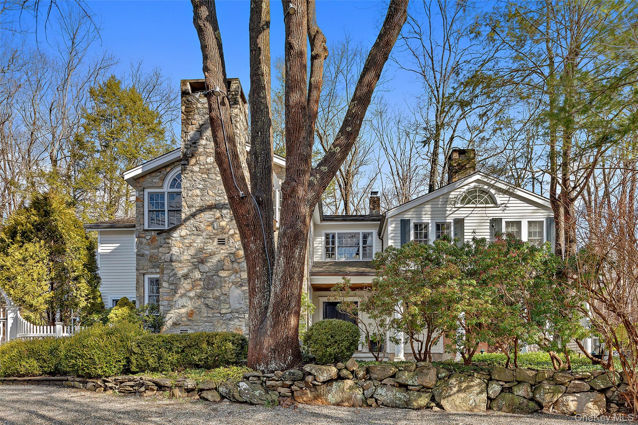 CIRCA 1880'S FARMHOUSE. Surrounded by breathtaking property! Old stone walls, specimen trees and flowering gardens. Carefully restored antique with wide board floors, period millwork and three fireplaces. Entry Hall with limestone floor. Beautiful Living Room with stone fireplace and French doors to the rear terrace and Sunroom. Formal Dining Room with raised paneling and stone-faced fireplace. Kitchen with Esmerelda granite counters and commercial grade appliances. Spacious Primary Suite with Sitting Room, fireplace and Bath. Guest Suite with Bath. Two additional rooms sharing Hall Bath. Detached Garage with fabulous Second Floor Game Room. Pool and spa. An incredible offering!