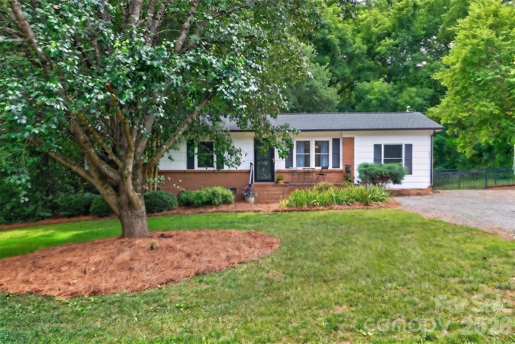 Tucked away at the end of a winding lakeside road in Belmont's desirable Paradise Point, this inviting ranch is where privacy meets lifestyle. Set on a beautiful, wooded lot with no HOA, you'll enjoy room to breathe while being just moments from Lake Wylie and the neighborhood boat launch. Warm hardwood floors, an open living space, three comfortable bedrooms, a flexible bonus room, and a large backyard deck create an easy, relaxed way of living. Crawlspace includes dehumidifier. Towering mature trees, peaceful surroundings, and frequent visits from local wildlife make this property feel like a private retreat, yet downtown Belmont is only six miles away. A rare opportunity to enjoy the best of lake living without sacrificing convenience.