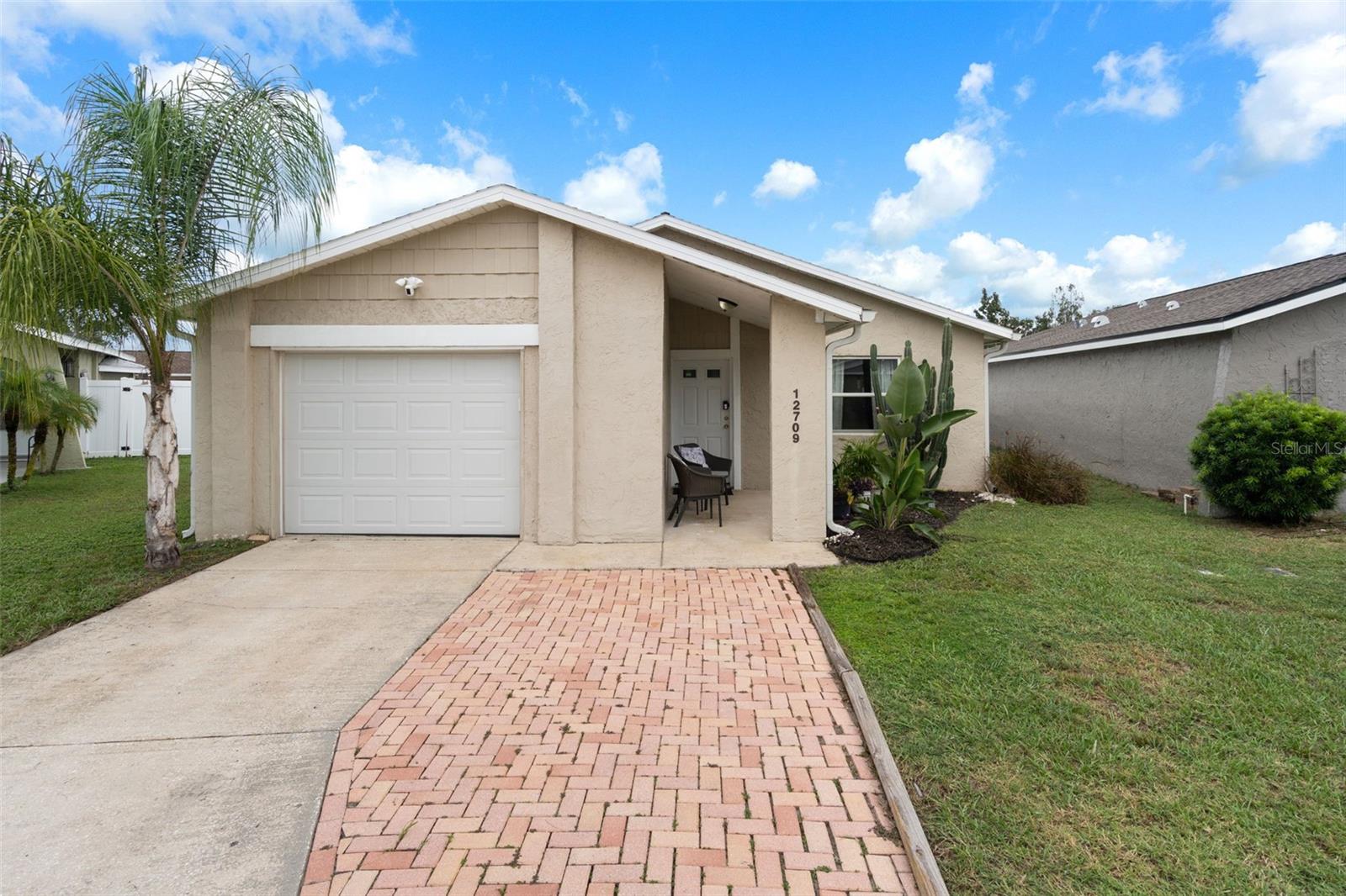 Everything you need and more!! Spacious layout, private back yard, stunning POOL and so much more!! This is the kind of home that immediately feels like it has been loved and cared for! From the moment you arrive, the pride of ownership is evident throughout, come check out your next home. This beautifully cared for property offers the perfect combination of comfort, functionality, and low maintenance living with everything you have been looking for. Featuring 2 large bedrooms, 1 full bathroom, a 1 car garage, and a spacious layout, this home is move in ready and ready, just bring your swimsuit and a toothbrush. Your home features low maintenance tile flooring throughout making everyday living and entertaining a breeze, while your gorgeous kitchen is equipped with stainless steel appliances and plenty of functionality. If the home doesn't take your breath away the backyard will!! Come over and enjoy your own private backyard oasis with a 2021 sparkling pool, a covered and screened in back patio, and plenty of room to relax, entertain, and enjoy the Florida lifestyle year round. The newer white privacy fence provides added privacy and creates a fantastic outdoor space for family, pets, or guests. Additional features include a 2024 water heater, an additional paver parking pad out front, and numerous upgrades. From the well maintained interior to the thoughtfully improved exterior, this home has been meticulously maintained and it shows. If you have been searching for a home that is truly move in ready, offers a great outdoor living space, POOL, centrally located in beautiful Hudson Florida and has been cared for, this one is a must see!
