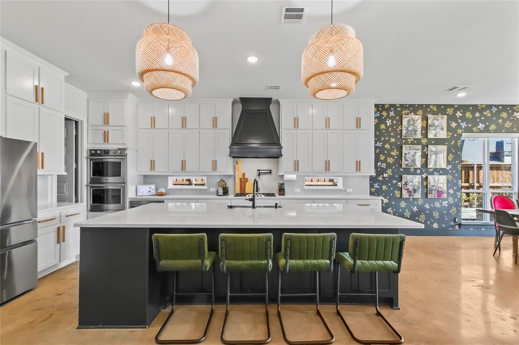 Step inside a home where creativity meets comfort in the heart of Tanners Mill. This 6 Bedroom, 4 Full Bath showpiece sits on over a third of an acre and offers an open, light-filled floor plan designed for both family living and entertaining. Durable stained and sealed concrete flooring flows throughout the first level, leading to a stunning chef's kitchen with a large island, double ovens, double dishwashers, walk-in pantry, and extended cabinetry for endless storage. The primary suite is a true retreat - tucked away for privacy and thoughtfully designed to unwind in style. Enjoy an extended walk-in shower with dual showerheads, dual vanities, and his-and-her walk-in closets, one offering convenient garage access. Every detail reflects comfort and sophistication, creating a peaceful escape after a long day. A custom utility room adds everyday convenience, featuring built-in space for multiple washers and dryers, built-in sink, and room for a full-size freezer - ideal fora busy household. Upstairs, the fun begins with a custom playroom featuring rock walls, climbing nets, and a built-in readying nook tucked under the spiral staircase - a kid's dream come true. Artistic wall murals throughout the home add warmth, personality, and creative flair that make every room feel special. Outside, enjoy an electric gated driveway and four-car garage, perfect for extra storage, hobbies, or weekend projects. With a spacious backyard, inspired design and location with top-rated Prosper ISD, North facing, and walking distance to the Tanners Mill park, this home captures the perfect balance of style, creativity, and family-friendly living.