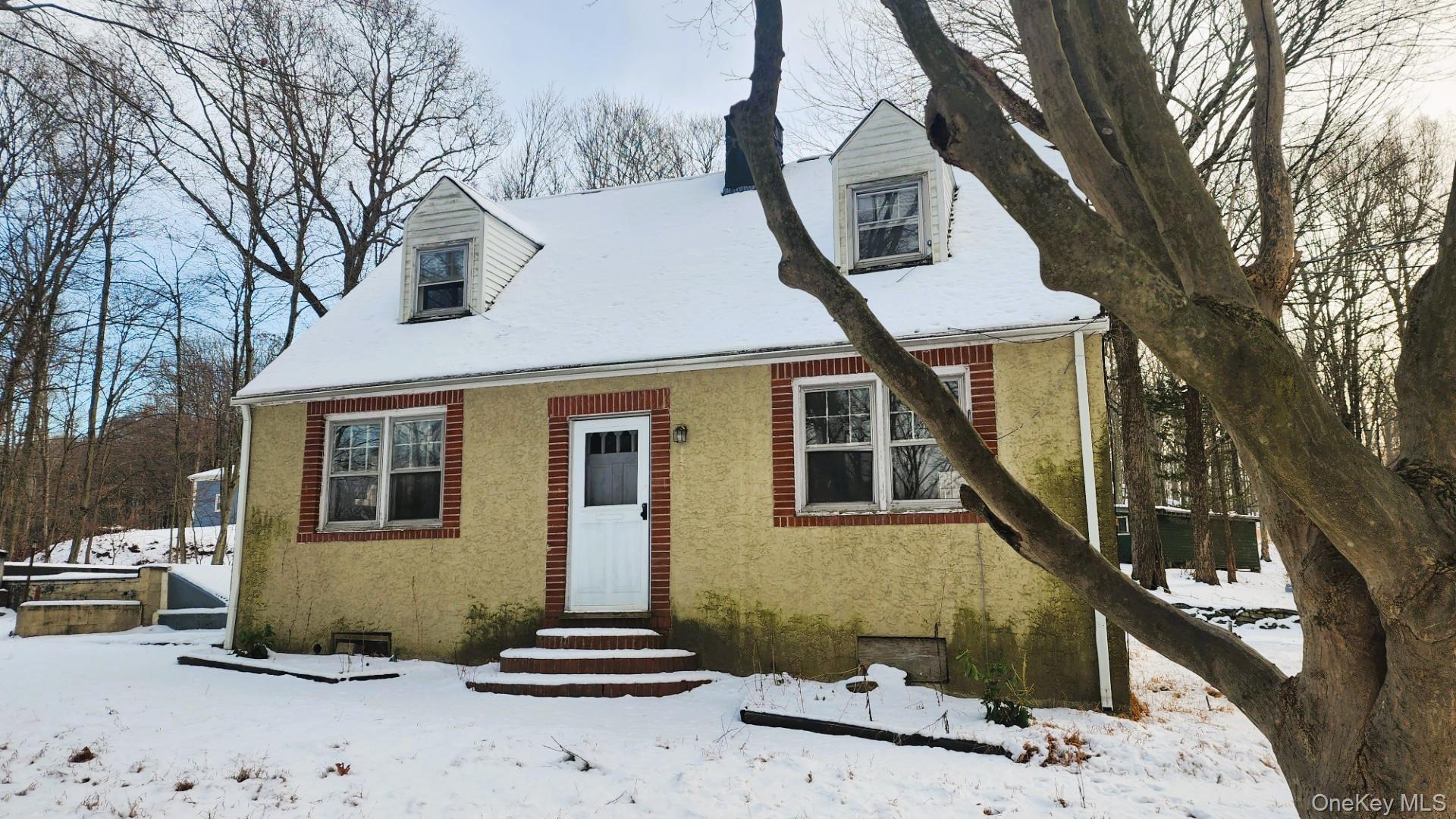 Stucco cape in North Salem with 2 acres.  Detached 2 car garage and additional outbuilding/shop.  2 bedrooms plus den.  Brick fireplace in living room.  Katonah/Lewisboro schools.  Very quick and easy access to I684 and only 6 minutes to the Goldens Bridge train station.