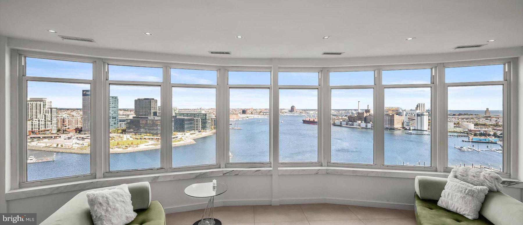Step inside this remarkable 5,437 square foot fully furnished bespoke residence and find breathtaking panoramic water and city skyline views unavailable anywhere else in Baltimore.  From sunrise to sunset these sweeping views span 180 degrees across 3 sides of the building and take you from the Inner Harbor to the Chesapeake Bay.  Located throughout the residence you will find 6 exterior balconies that complement these amazing interior views and provide a seamless transition from the outside world into a level of wraparound splendor.  Featuring 7 bedrooms, an office/den, 5 full ensuite bathrooms and 1 entryway powder room this is luxury living at its’ finest and all on one level.  A centrally located and spacious open floor plan provides for endless blissful entertaining between the North and South residence wings.  Sophisticated modern design & customization is featured throughout including a gourmet kitchen with Miele appliances, butler pantry, remote control window treatments, custom lighting and spacious walk-in laundry room.  Extra household items can be stored within the 3 private deeded storage lockers located within the building.  Deeded parking spaces for 5 vehicles is provided for within the lower level parking garage.  Community amenities include valet parking, 24/7 front desk and security & on-demand security escorts, private parking garage, heated indoor pool, outdoor pool, outdoor entertaining area, private fitness center, multiple guest suites, conference room, meeting room, business center, event room, game room, concierge services, private trash & snow removal, marina, Bellini’s dock bar, DiPasquale’s Italian deli & market, waterfront promenade walking/jogging/biking path and beautifully landscaped grounds.  A conveniently located water taxi can take you to explore any neighborhood in the city. With countless shopping, dining and entertaining options just minutes away from this centrally located Inner Harbor property you can enjoy a lifestyle offered nowhere else in Baltimore.