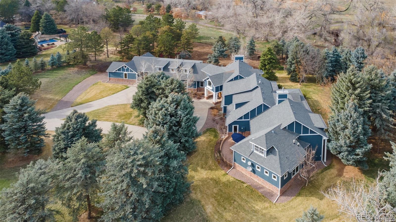 Welcome to this stunning Greenwood Village estate, set on 2.33 acres of lush land. This home combines luxury and tranquility with impeccable craftsmanship. Inside, you'll find five spacious ensuite bedrooms and 6 bathrooms, including a primary suite with a cozy fireplace, wet bar, two huge walk-in closets, and a spa-like bathroom with heated floors and a second fireplace. There's also a private loft—perfect for a home office or retreat. The main level features a guest suite for ultimate comfort and privacy. The chef's kitchen is a dream, with two large islands, three ovens, a six-burner gas range, dual dishwashers, and a generous pantry. Upstairs, two more ensuite bedrooms offer custom storage and plantation shutters, with one hiding a fun playroom. Attached three car garage offers the perfect amount of space and storage. A separate in-law suite comes with its own 2 car garage, living space, full kitchen, laundry room and bedroom large enough for a king size bed! Outside, enjoy three beautiful patios, a barn with a tack room and pasture, and a creek running through the property. This property allows for horses! This estate offers beauty, privacy, and endless possibilities for relaxation and entertaining