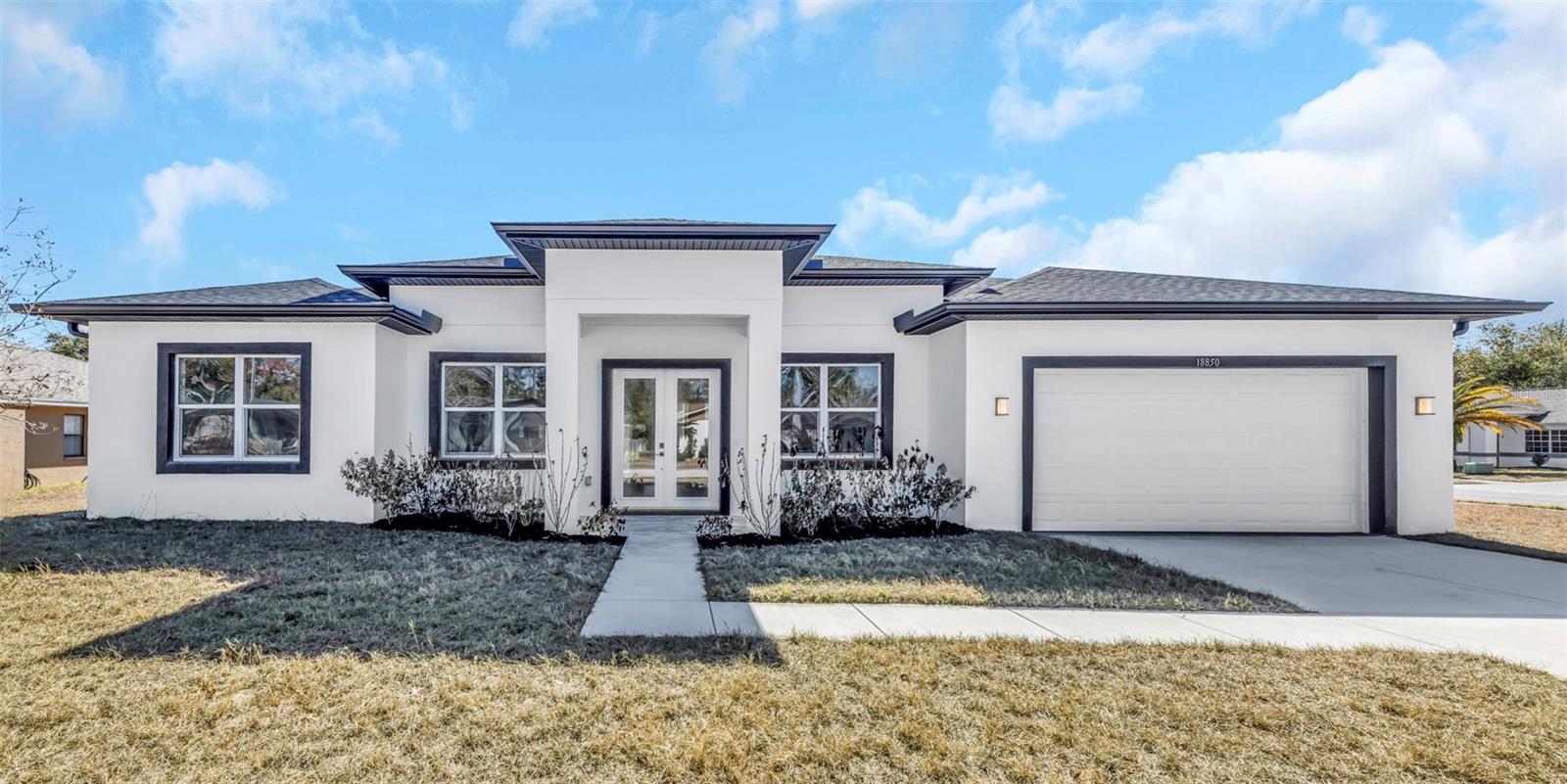 Experience the height of modern coastal living in this stunning, brand-new all-block construction home. Designed with both style and durability in mind, the residence features a thoughtful split floorplan. At the heart of the home lies a sophisticated kitchen, anchored by a sleek island with waterfall countertops that flow seamlessly into an open-concept living space. The oversized primary suite serves as a true sanctuary, complete with a sprawling, spa-inspired bathroom highlighted by a gorgeous standalone soaking tub. For added convenience, a second bedroom features its own private en-suite bathroom, complemented by a third versatile bedroom and bathroom, and a spacious 2-car garage. Outside, a built-in irrigation system keeps the grounds pristine, allowing you more time to enjoy the incredible surrounding landscape.Just minutes away, a wealth of premium conveniences and dining destinations await. Whether you are seeking everyday essentials at Publix or Super Walmart, or browsing major retailers like Best Buy and JCPenney, the area provides an extensive array of shopping and big-box stores to satisfy every need. From casual eateries to diverse dining options located just minutes from your front door.  This home’s location offers an unparalleled Florida lifestyle, situated just 15 minutes from the legendary Weeki Wachee Springs State Park, where you can witness the world-famous mermaid shows, explore the turquoise waters of the spring-fed river by kayak, or enjoy the slides at Buccaneer Bay. Nature lovers will appreciate being moments away from the Aripeka Sandhills Preserve for peaceful birdwatching and trails, as well as Hudson Beach, a waterfront gem perfect for boating and watching Gulf sunsets.