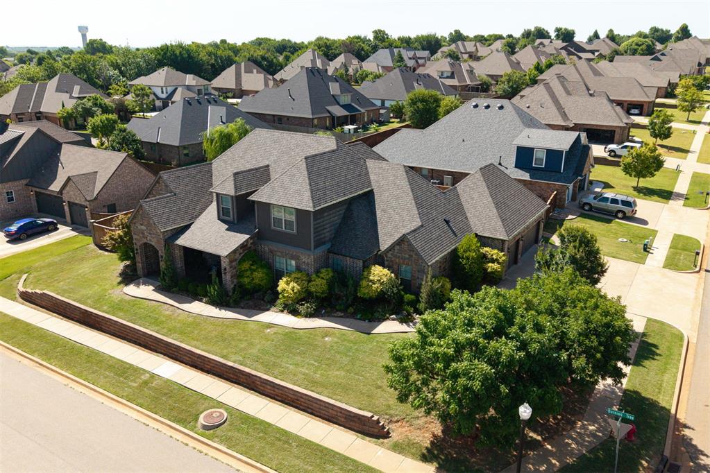 Welcome to 2017 Providence Drive—an exceptional home situated on a spacious corner lot in the highly desirable Hallbrooke community of NE Norman. This move-in ready beauty offers 3,900 square feet of thoughtfully designed living space, featuring 5 bedrooms, 3.5 bathrooms, a dedicated study, media room, and game room. The chef’s kitchen impresses with granite countertops, a massive island, 6-burner gas cooktop with griddle, convection oven, and built-in microwave. Just off the kitchen, you’ll find a private bar with its own ice maker and sink—perfect for hosting. Comfort meets efficiency with a whole-house geothermal HVAC system, built-in surround sound, and a full security system with cameras that will remain with the home. Step outside and enjoy your personal backyard oasis, complete with a sparkling swimming pool and diving board, relaxing hot tub, outdoor fireplace, and a fully equipped outdoor kitchen with built-in grill. Hallbrooke residents enjoy access to top-notch amenities, including a beautiful clubhouse, scenic walking trails, private ponds, and a resort-style community pool with waterfalls and lap lanes. Ideally located near I-35, the University of Oklahoma, shopping, and University Town Center, this home offers the perfect blend of luxury, comfort, and convenience. Don’t miss your chance to make it yours!