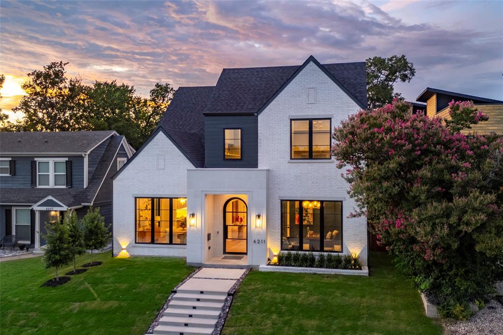 One block from Tietze Park and zoned to Mockingbird Elementary, this newly completed Lakewood Heights home by Select Custom Homes pairs architectural interest with timeless finishes and thoughtful functionality. An 18' vaulted ceiling creates a stunning first impression in the dining room, while the study offers a bespoke built-in and private workspace. The main level features 11' ceilings, smooth Level 4 walls, and a dramatic fluted quartzite fireplace flanked by custom built-ins with arched detailing and fluted accents. The kitchen is anchored by rift-sawn white oak cabinetry and Mont Blanc quartzite countertops, which continue through to the bar. A Bertazzoni range and Sub-Zero refrigerator complete the space. A downstairs guest suite with ensuite bath opens conveniently to the covered patio—an ideal layout should you add a pool. Upstairs, a game room with an A-frame ceiling and another additional flex space—perfect for a home gym or second office—add versatility. The primary suite is a true retreat with a vaulted ceiling and central beam. Its spa-style wet area includes a freestanding tub and dual-head spray shower over marble mosaic flooring. Fluted oak cabinetry and marble countertops continue in the bath, while the vaulted walk-in closet features a built-in dresser. Each secondary bedroom is generously sized with its own ensuite bath, all featuring custom-designed vanities, marble countertops, and curated tile pairings. Outdoors, a covered patio with fireplace, grill, and beverage fridge overlooks a spacious backyard that offers a seamless setup for a future pool, with a pre-planned utility layout and electrical capacity already in place. AV pre-wiring and mesh internet provide the modern infrastructure today’s lifestyle demands. Every detail—inside and out—has been carefully considered to create a home that’s as functional as it is unforgettable