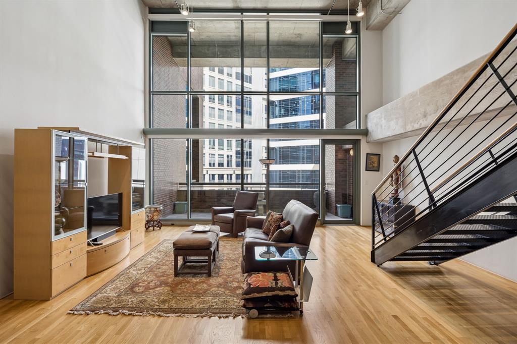Experience authentic Uptown loft living at iconic 1999 McKinney Lofts. This highly walkable urban condo is a beautifully maintained residence that blends industrial-inspired architecture with expansive living spaces, soaring ceilings, exposed ductwork, and interior brick walls, giving the home true urban character. Approximately 20-foot floor-to-ceiling windows with motorized shades create a dramatic focal point in the main living area while filling the space with natural light throughout the day. The open kitchen-and-living design offers exceptional flexibility for entertaining and everyday living, with generous room sizes rarely found in newer construction. A large private balcony overlooks vibrant McKinney Avenue below, placing the energy of Uptown right outside your door.The oversized first-floor bedroom functions beautifully as a secondary primary-style suite, while the expansive upstairs primary retreat includes a loft-style secondary living area overlooking the main level. Both bedrooms are exceptionally generous in size and offer strong separation and privacy. Storage space locker also comes with the unit and located near the fitness center.Residents enjoy 24-hour concierge and security services, a fitness center, a conference room, a pool & spa, grilling stations, outdoor lounge areas, a fire-pit gathering space,  and 2 secured parking spaces. Just moments from the McKinney Avenue Trolley, Klyde Warren Park, the Dallas Arts District, Fearings, The Crescent, Whole Foods, American Airlines Center, Nick & Sam’s, Sixty Vines, Moxies, Del Frisco’s, and so much more.Furniture can be sold. Refrigerator, Washer, and Dryer convey with purchase. 2 Parking spots Floor 2 spots 39 &  40A rare opportunity to own in one of Uptown Dallas’ most recognized luxury loft buildings and enjoy a true lock-and-leave lifestyle in the heart of the Dallas in a premier Uptown location.