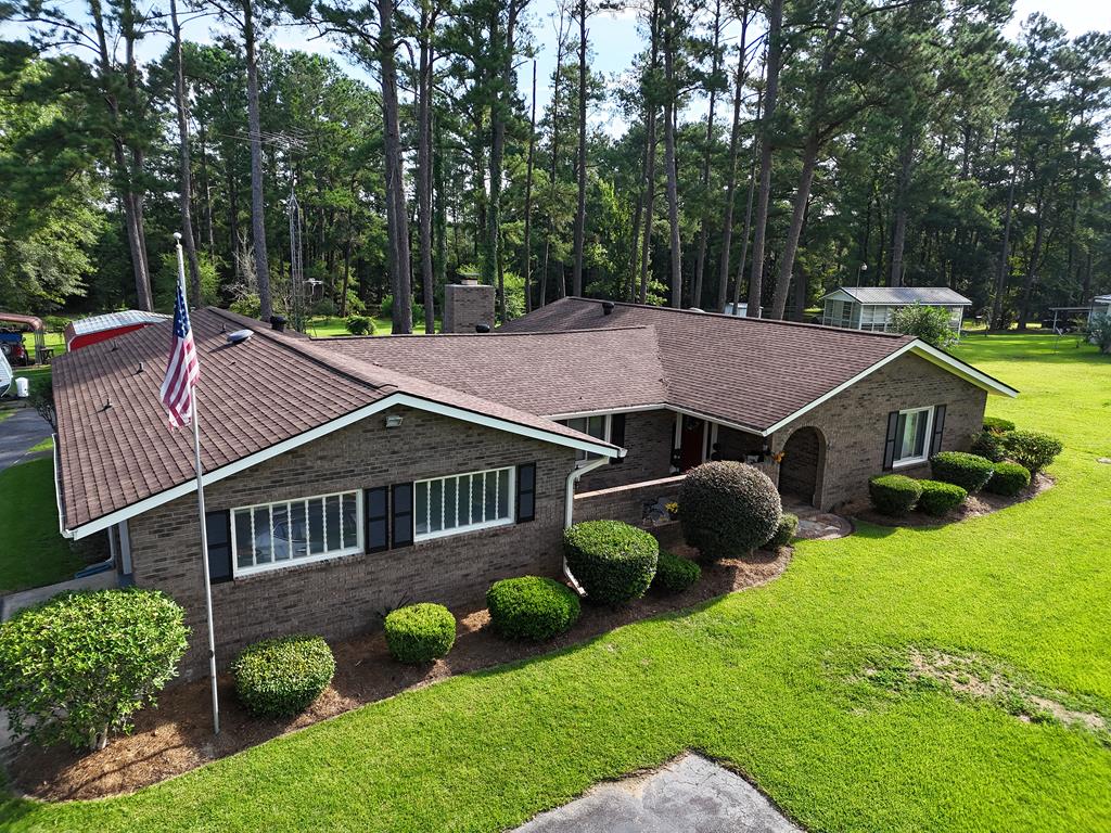 The home of your dreams awaits on Hwy. 65 in Pelham, GA! Follow the meandering driveway through the beautiful front yard to this stately, 3BR/3Bath brick home. The front entrance features great arches and a nice courtyard. Inside, you will find an enormous fireside living and dining room, wonderful kitchen, three great bedrooms, a cute laundry room, and an all-purpose room that can be used as a fourth bedroom, home office, and MORE! At the back of the house there is a nice screened porch, overlooking a gorgeous backyard filled with fruit trees, grapevines and mature plantings. There is also a great outbuilding and shed for your vehicles, plus an attached carport and convenient mud room. Call your favorite agent TODAY for a closer look at this magnificent home! Click here for virtual tour: https://my.matterport.com/show/?m=x54yt6xwYto&mls=1