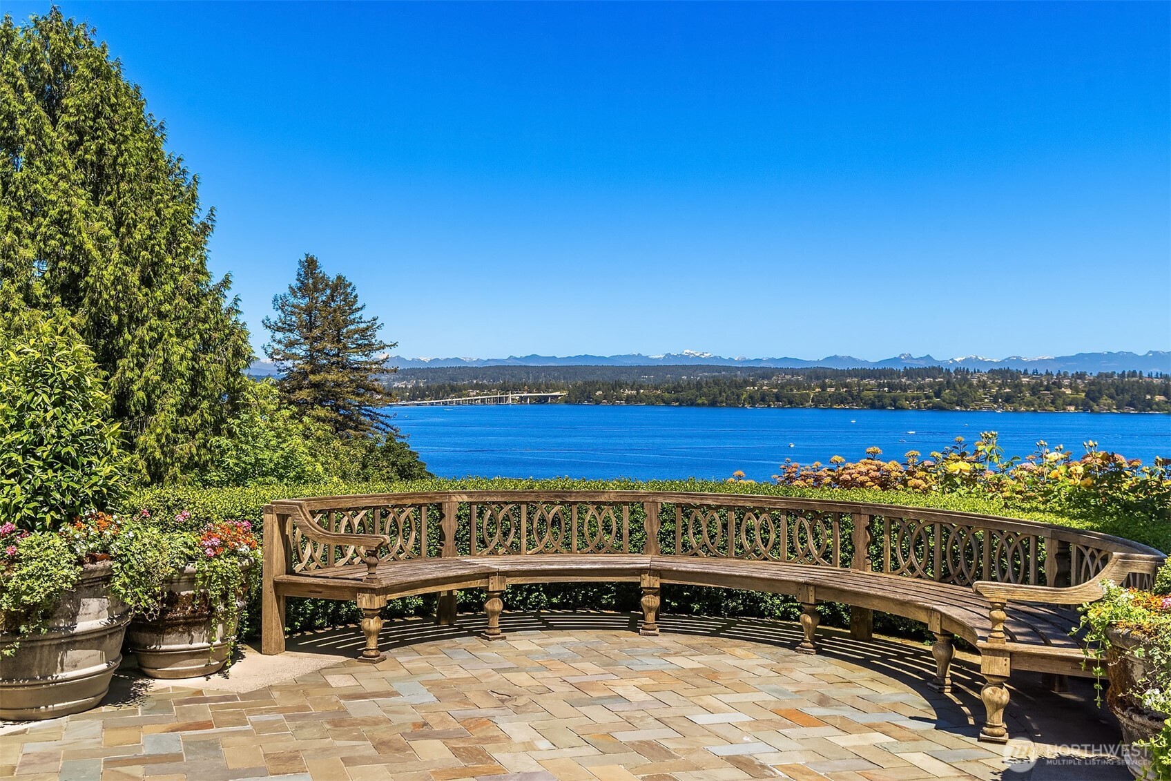 Extraordinary residence built by a seamless collaboration of craftsmen, architects & designers using finest materials. Prominent Washington Park location w/ breathtaking panorama of Lk Washington & Cascade Mountains. Privately screened by a gated brick motor court & hornbeam hedge, this British Manor offers understated elegance found inside & out, affording the ultimate in both casual living & gracious entertaining. Unparalleled richness in time-honored finishes include limestone floors, antique aggregate balusters, French polished paneling, hand-crafted moldings, 5 fireplaces, leaded windows. Meticulous maintenance & attention to detail. Broad, verdant garden terraces. Private Street to street double lot. A memorable, simply stunning home.