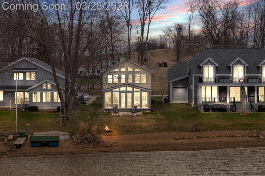 Sand Lake lakefront! Beautiful Sunset views with the Perfect sandy beach, gradual walkout wonderful for wading, swimming and relaxing. Great home for year-round living or a dream vacation cottage. (Totally updated 2018-2022). Amazing 3-season room adds almost 300 sqft of additional living space. Spacious Open Floor plan. This place has it all- Soaring ceilings, fireplace, hardwood floors large family room, kitchen and dining room with main floor bedroom, bath & laundry. Upper level has fantastic view from the large family room. Plus 3 bedrooms and bath. Reverse osmosis & water softener systems and all Appliances included! Whole house generator. This property is made for entertaining! Come and enjoy the Irish Hills on All-sports Sand Lake! Boat Launch and overflow parking a few homes away