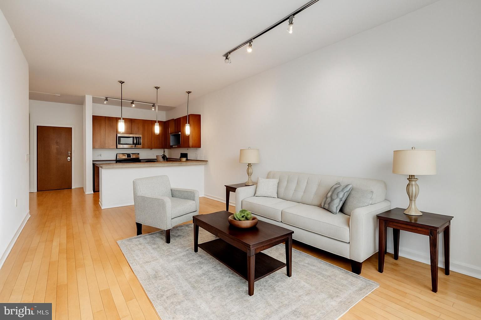 condominium community in the heart of historic Mount Vernon! This bright and spacious 2-bedroom, 2-bath home features an open layout, freshly painted interior, and durable tile flooring throughout—no carpet. The kitchen includes an LG refrigerator with craft ice maker, brand-new dishwasher, and in-unit washer/dryer. The primary suite offers a generous walk-in closet and roll-in shower, while the second bedroom is perfect for guests or a home office. Enjoy two deeded garage parking spaces (rare for downtown living), secure building access with Lockly smart entry, Amazon package lockers, and an elevator. HOA fee includes water, gas, trash, building maintenance, and reserves. Ideally located near Penn Station (MARC & Amtrak), MICA, UB, Peabody, cafés, and cultural venues. Quick access to I-83 and downtown. Pet-friendly and move-in ready—experience easy, convenient city living at Twelve09