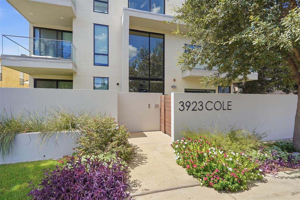 At 3923 Cole Avenue, this stunning single level contemporary condo offers the perfect lock-and-leave lifestyle and walkability, where city living begins at the front door: Cole Park is across the street, the Katy Trail entrance is just over a block away, and the restaurants, shops and energy of West Village, State Thomas and Oak Lawn are all close at hand. Built by the developer as his personal residence, Unit 201 reflects a more considered approach to condominium living. The entire home is arranged on one level, beginning with a proper entry vestibule that opens to generous living and dining spaces. Tall ceilings and broad windows bring in abundant light, while white oak floors and a gas fireplace with a quartzite surround add warmth and architectural presence. A covered balcony creates a welcome sense of nature in the heart of Uptown. The kitchen is tailored and understated, pairing European cabinetry with white quartz countertops and stainless-steel appliances. An eat-in area allows for casual mornings, while the open layout keeps the kitchen connected to dinners and evenings with friends. Secured entry, elevator access, gated garage parking, private storage and an electric vehicle charger make this an especially polished lock-and-leave home; equally suited to a morning on the Katy Trail, an afternoon in the park or a night out without getting in the car.
