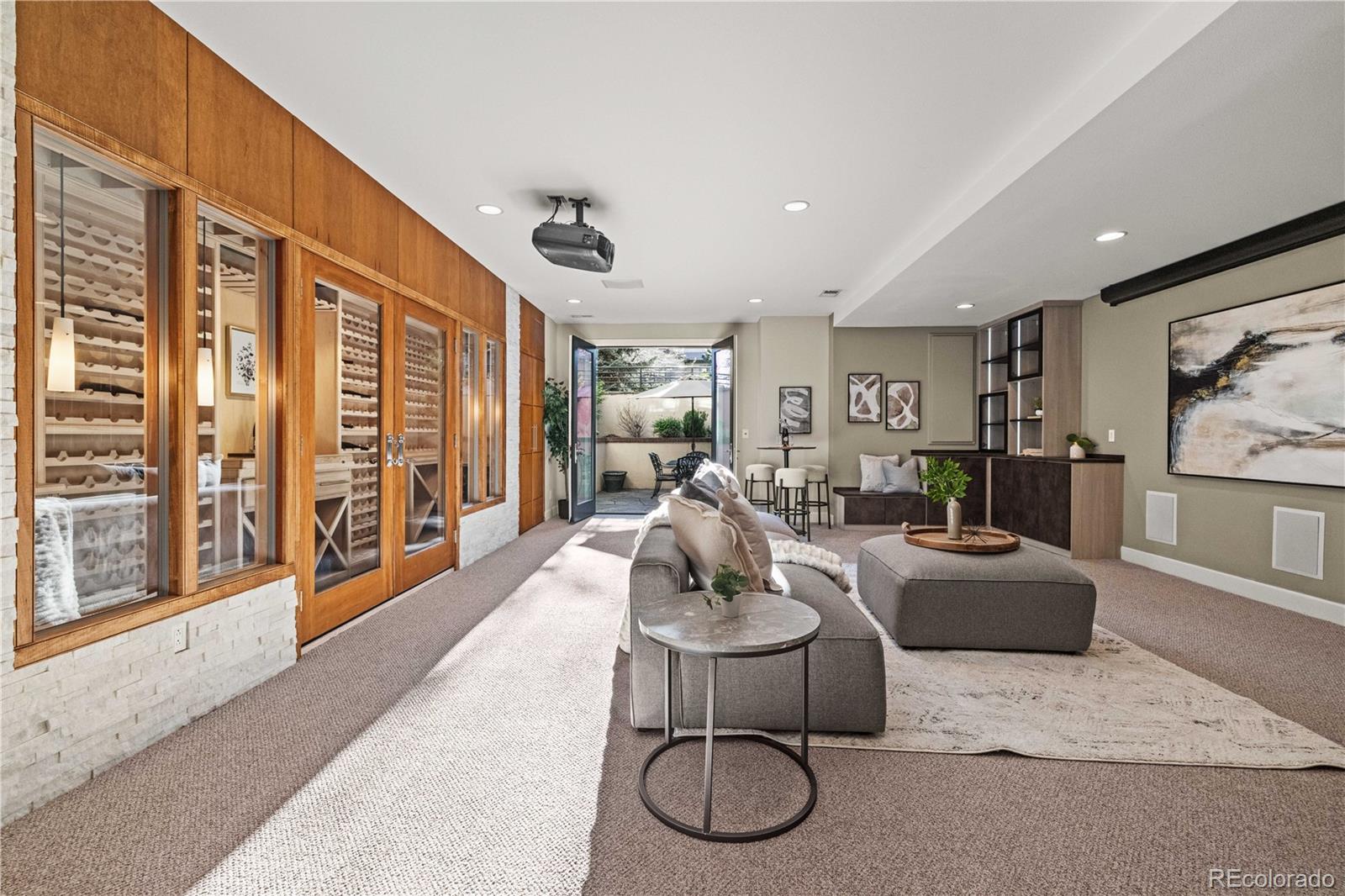 Welcome to 128 Garfield Street in Denver’s Cherry Creek neighborhood, a 4-bed, 5-bath home offering nearly 5,000 square feet of thoughtfully designed living space and extensive updates, all with no HOA. The open-concept main level features 10-foot ceilings, abundant natural light, and a seamless flow between the kitchen, dining, and living areas. The kitchen is equipped with JennAir, Viking, and LG appliances, combining high-performance cooking with everyday functionality. Just off the kitchen, a private outdoor space creates an easy extension for dining or gathering. Upstairs, the home offers two primary bedroom suites, each with its own bathroom and generous closet space, providing flexibility for guests, shared living, or work-from-home needs. An elevator services all levels, adding convenience and long-term accessibility. The lower level expands the living space with a walk-out basement, outdoor patio, and a custom wine cellar with capacity for approximately 600 bottles. A dedicated home theater area with projector and additional storage adds to the versatility of the space. At the top level, a rooftop terrace offers an additional place to relax, entertain, or take in Colorado’s sunshine. Across all three outdoor spaces—from the kitchen, the walk-out basement, and the rooftop—this home is designed to extend living beyond the interior, making it feel even more expansive. Throughout the home, you’ll find recent upgrades including new Pella windows and patio doors, interior and exterior paint 2024, new carpet, fresh interior paint 2024, and updated mechanical systems, including A/C and water heater. Additional features such as California Closets, dual laundry areas, and an epoxy-coated garage floor enhance both comfort and functionality. Located in Cherry Creek, with close proximity to local dining, shopping, parks, and downtown Denver, this home offers a combination of space, flexibility, and indoor-outdoor living in one of the city’s most vibrant neighborhoods.