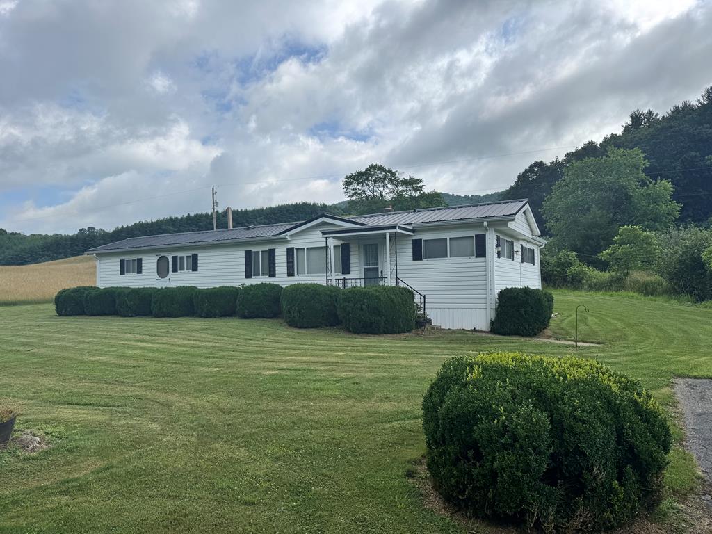Take a look at this well-maintained home that would be a great starter home or weekend getaway. This home sits on a level lot with a small stream running through it and has outbuildings and a paved driveway. The home features low maintenance vinyl siding and a metal roof. The home also features updated electrical including some new wiring and a 200 Amp service. There has been plumbing upgrades and new flooring installed. This property is located across the road from Big Wilson Creek, a stocked trout stream. This property is located only minutes from Grayson Highlands State Park, Jefferson National Forest, and the New River.
