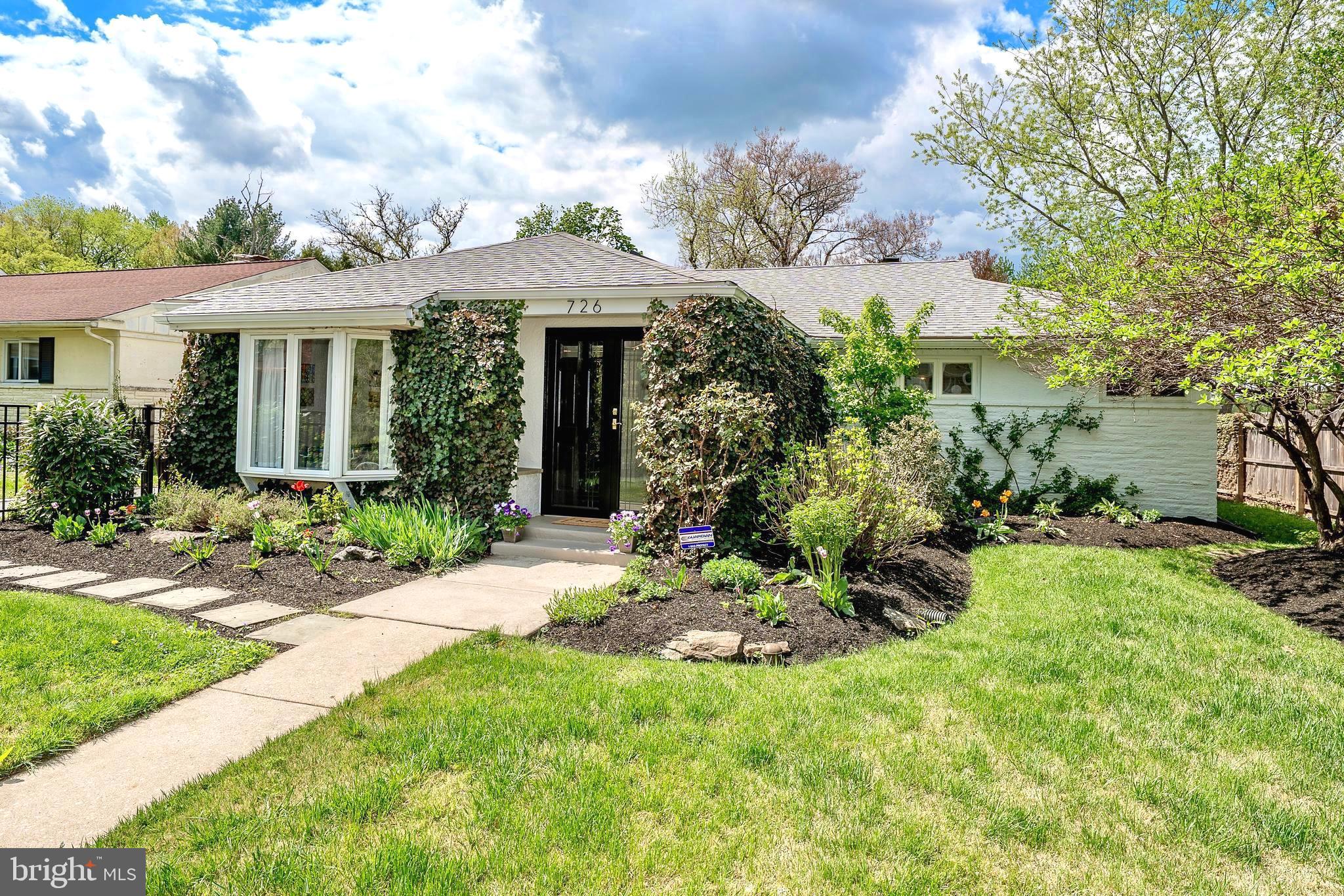 Offering far more space than meets the eye, this expanded 4-bedroom, 2.5-bath ranch in sought-after College Park combines a surprisingly open interior with beautifully curated outdoor living. A dramatic vaulted foyer with an oversized skylight creates a bright and welcoming first impression, leading into the home’s expansive main living spaces. Gleaming hardwood floors run throughout much of the first floor, while the spacious living and dining areas flow easily together and connect to a fireside family room, creating a layout that is both inviting and versatile for everyday living and entertaining. The kitchen is filled with natural light and features all-new stainless steel appliances, tiled flooring, a vaulted ceiling, and a sunny eat-in area with access to both the driveway and the rear deck. Tucked away from the main living spaces, the bedroom wing includes four nicely sized bedrooms, each with custom closet organization. The hall bath has been refreshed with new exhaust fan, toilet and updated fixtures, while the private primary suite offers added comfort with a newer Mitsubishi high-efficiency split system for heating and air conditioning, an en-suite bath with stall shower, and an oversized walk-in closet with direct access to the rear deck. The finished lower level adds valuable flexibility, offering additional living space with wall-to-wall carpeting, a half bath, workshop area, and laundry room with new front-loading washer and dryer. Significant improvements include a roof installed in 2022, all-new stainless steel kitchen appliances, new washer & dryer, and updates to both full baths including new toilets and exhaust vents. Outside, the property is every bit as special as the interior. The gated front yard is a true gardener’s dream, while the fully fenced backyard offers a peaceful and private retreat with a large deck that was recently repainted, two retractable awnings, and an array of beautiful plantings that create the perfect setting for relaxing, outdoor dining, or entertaining. Quietly set within one of Lower Merion Township’s most popular communities, yet just minutes from trains, major roadways, Main Line destinations, and Center City Philadelphia. This home offers a wonderful combination of space, character, updates, and location, all within the Lower Merion School District.