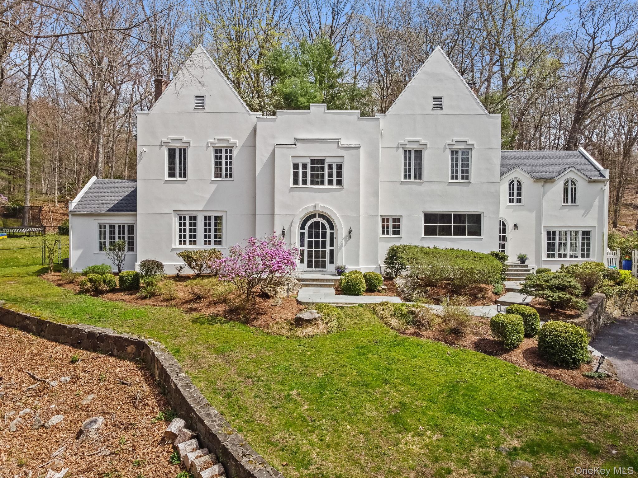 This beautifully appointed, grand and stylish Colonial seamlessly blends grand-scale entertaining with intimate everyday living. Highly sought after location at the end of a quiet cul-de-sac, the home offers exceptional privacy while remaining just minutes from Bedford Village, Scotts Corners, and acclaimed Jean-Georges’ Inn at Pound Ridge. Thoughtfully laid out with a designers aesthetic, beautifully renovated kitchen and baths, exposed beams and high vaulted ceilings showcase the highest level of craftsmanship throughout. Highlights include custom millwork and cabinetry, rich hardwood floors, romantic fireplaces, top-tier appliances and 3 car garage. The expansive primary suite is a true WOW, with vaulted ceilings, walk in closet and lovely fireplace seating area complemented by 3 additional sun-filled bedrooms.A separate guest house with kitchen and bath—ideal as a studio, pool house, or private workspace—adds versatility to the property. Outdoors, a sparkling heated pool is perfectly set within a picturesque, beautifully landscaped retreat, creating a true country escape.