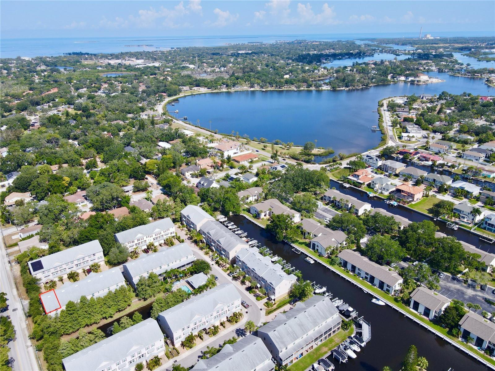Experience the ultimate maintenance-free coastal lifestyle in the highly sought-after gated waterfront community of Callista Cay in Tarpon Springs. One of the few townhomes in the area with no history of flooding during any hurricanes, this beautifully maintained end-unit also includes an assumable flood insurance policy, approximately $610 annually, providing added peace of mind and potential savings. Built in 2020, this spacious three-story home features 3 bedrooms, 2.5 bathrooms, and 1,828 square feet of thoughtfully designed living space.The oversized two-car garage includes an 8-foot-tall door to accommodate larger vehicles with extra space for golf carts, water toys, or a boat trailer, along with upper storage racks and additional under-stair storage. The home is also future-ready with room in the garage for a potential elevator installation.The main living level offers an open-concept design ideal for entertaining. The chef's kitchen features solid wood soft-close cabinetry, quartz countertops, stainless steel appliances, an induction stove, and an extended center island with breakfast bar seating. A convenient half bath is located just off the kitchen, perfect for guests. The spacious living area opens to a screened balcony overlooking tranquil cypress trees and a peaceful pond, creating the perfect space for coffee in the morning or relaxing in the evening.Upstairs, the primary suite includes tray ceilings, a cozy alcove, an extended walk-in closet, and a newly remodeled en-suite bathroom (February 2025) featuring dual vanities and a linen closet. Two additional bedrooms share a Jack-and-Jill bathroom, while the upstairs laundry room offers added shelving and storage.This beautifully maintained end-unit townhome offers added privacy, abundant natural light from extra windows, and the peace of mind of an elevated interior location with no history of flooding during any hurricanes. Additional features include fire suppression sprinklers and an elevation certificate.Designed for boating enthusiasts, Callista Cay offers direct canal access to the Gulf. Multiple community boat slips are available for lease or purchase (subject to availability), and the seller is willing to assist the buyer in navigating the lease or purchase process.Callista Cay offers a low-maintenance lifestyle with a gated entrance, community pool, clubhouse, and beautifully maintained grounds. Ideally located just minutes from the historic Sponge Docks, Fred Howard Park, Sunset Beach, local marinas, the Pinellas Trail, waterfront dining, antique and boutique shopping, and downtown Tarpon Springs, this exceptional end-unit combines the best of Florida's boating lifestyle with the security and peace of mind of an elevated interior location.