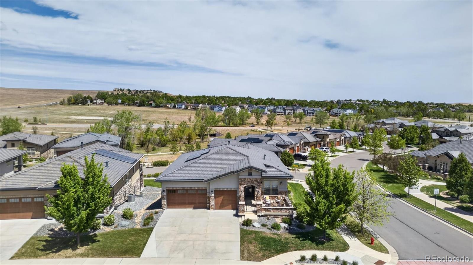 Luxury, lifestyle, and absolutely zero compromise. Welcome to Calmante, one of Superior's most coveted low-maintenancecommunities, designed for those who appreciate elevated one-level living without sacrificing style, space, or sophistication. Perfectly positioned on a premium corner lot with beautiful mountain views and open space surroundings, this impeccably maintained ranch-style home was lovingly cared for by its original owners and thoughtfully upgraded throughout. From the moment you enter, you'll notice the difference: rich hardwood floors, abundant natural light, plantation shutters, soaring open spaces, and a floor plan that simply lives beautifully. The kitchen is an entertainer's dream with a full Viking appliance package, six-burner gas range, double ovens, microwave drawer, wine refrigerator, ice maker, two paneled dishwashers, expansive granite island, walk-in pantry, and butler's bar area designed for effortless hosting. The open-concept design seamlessly connects the kitchen, dining, and family room, where a stacked stone fireplace and expansive windows frame the stunning Colorado backdrop. Step outside to the oversized covered deck and enjoy mountain views, open space, and peaceful trail surroundings that make this community so special. The main-floor primary suite offers the kind of everyday luxury buyers are searching for: abundant light, spa-inspired five-piece bath, oversized soaking tub, large walk-in shower with full glass enclosure, dual vanities, private water closet, and generous walk-in closet. A secondary main-floor ensuite provides ideal flexibility for guests or multigenerational living. Downstairs, the walkout basement expands the home beautifully with a massive recreation space, additional bedroom and oversized bath, plus exceptional storage. This is Colorado living for the buyer who wants elegance, ease, views, and impeccablecondition - all just minutes from Boulder, Louisville, dining, shopping, trails, and Highway 36 access.