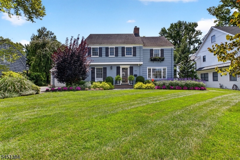 Beautifully updated four bedroom, three and a half bath, pristinely landscaped colonial situated on a quiet street. Close to top schools, shopping, downtown, and the train to NYC, this home has it all. An attached two car garage means never being caught in the rain with the groceries, and there is not a surface in this home that hasn't been thoughtfully updated. Step into a bright living room centered around a gas fireplace, which flows into the family room, where sliders open to a lovingly landscaped backyard, complete with a raised paver patio and built-in gardens, an idyllic setting for both quiet mornings and lively gatherings. Upstairs, the primary suite is a true retreat, crowned by soaring cathedral ceilings and anchored by a charming built-in bench and a generous walk-in closet. The primary bath impresses with a freestanding italian marble tub and a separate walk-in shower, offering a daily escape without leaving home. Three additional bedrooms and a hallway bath round out the upper level, while the walk-up attic offers exciting space in the making. The basement expands the living space further, with a recreation room, high ceilings, and a full bath. Meticulously maintained and move-in ready, this Westfield colonial is a rare opportunity to enjoy elevated living on one of the town's most coveted streets.
