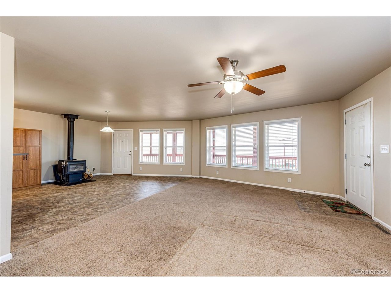 Beautiful ranch style home on fully finished walk out basement features 4 bedrooms and 3 bathrooms. The main level offers a large kitchen, dining room with wood burning stove, sun room, living room and three bedrooms. The primary bedroom features a luxurious en suite primary bathroom. The spacious kitchen offers ample cabinetry and stainless steel appliances. The basement is fully finished with large family room and massive bedroom with en suite 3/4 bathroom and wet bar. The basement is situated with private entry for a studio mother in law suite. The home has a new roof (April 2026) with transferrable warranty. The low maintenance stucco exterior and the large sun room are just an added bonus. Main level is forced air heat and the basement finish is electric baseboard. The shop is approximately 30 x 40 with concrete floor and power. The barn is approximately 40 x 60 with 3 large stalls, loft and 10 x 40 ft overhang/livestock shed. There are two 10 x 12 livestock sheds and property is fenced and cross fenced into several pastures. The home features 360 degree views! Buyer to verify all information.
