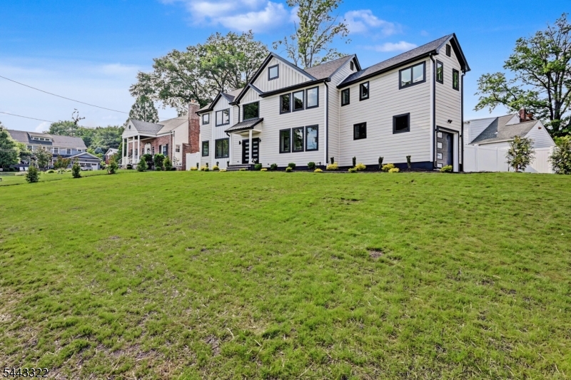 Welcome to this exceptional 6-bedroom, 6-bathroom newly built home, expertly constructed on an existing foundation and ideally located on Cranford's sought-after North Side overlooking Nomahegan Park. This home blends generous space, premium craftsmanship, and timeless design.The exterior features Cobblestone Hardie Plank siding and Andersen 400 Series casement windows. Inside, the first floor offers an elegant dining room, bedroom with a full bath for guests or a home office, and an open-concept family room flowing into a designer kitchen with Viking appliances. A sliding door leads to the patio and backyard. An attached one-car garage and oversized driveway accommodate 8+ vehicles.The finished basement ( 1,300sq  extra living space) includes a full bath and flexible space for a recreation room, gym, or media room. Upstairs, the luxurious primary suite offers walk-in closets and a spa-inspired bath, plus a private princess suite, two additional bedrooms, another full bath, and a laundry room. The finished third level provides an additional bedroom or flexible living space.Minutes from downtown Cranford, NJ Transit to NYC, top-rated schools, parks, restaurants, caf s, and boutiques, this exceptional home offers luxury living in one of Union County's most desirable communities. Enjoy award-winning dining, year-round community events, easy access to major highways, exceptional curb appeal, quality finishes throughout, and move-in-ready convenience for today's lifestyle.