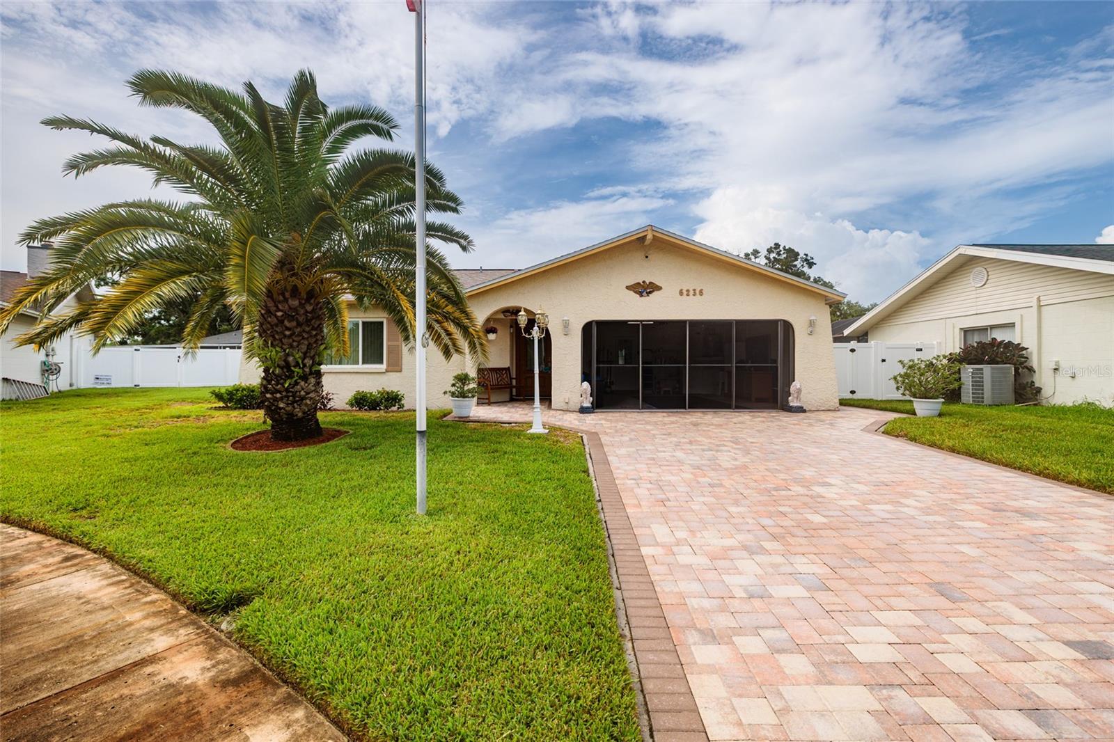 One or more photo(s) has been virtually staged. New to market! NO FLOOD INSURANCE REQ. Freshly updated 2 bedroom, 2 bath home in the Autumn Run community, City of Pinellas Park. Brand new Roof and AC - Installed 7/2025. Tile and carpets steam treated just before listing. Flooring includes light gray faux wood grain tile throughout, bedrooms are carpeted. Kitchen updates include stainless steel appliances, granite countertops, raised tray ceiling with can lights and a large closet pantry. Primary and Hall Bathrooms have been completely renovated. Fresh paint inside. Exterior painted 2016. Brick Paver Driveway. Hurricane/Storm Rated: Windows, Front Door and Back Door. The lawn stays affordably lush on reclaimed water, current owner has landscaping service. 2nd refrigerator in garage conveys. Screened patio is perfect for outdoor entertaining and the paver deck in the backyard is just begging for a spa! Optional: Flood Policy available for 'no fee transfer' and proration at closing. Affordably priced, turn key, absolutely spotless. Central Pinellas County location provides easy access to our airports, beaches, and other famous Pinellas attractions. Hop on the expressway to making your home buying dreams come true. Be sure to ask for a Feature Sheet on this home.