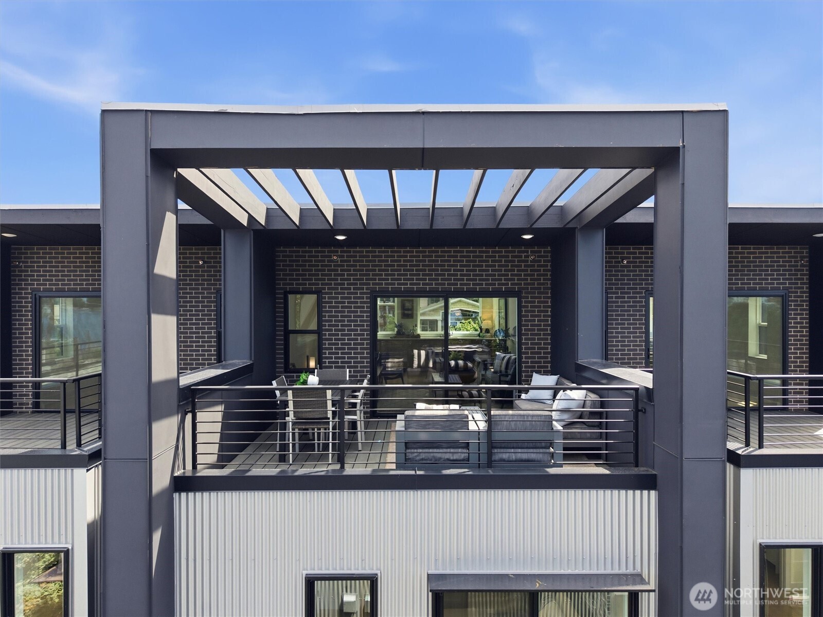 Located within the gated Harbor 26 community in the heart of Eastlake, this spacious 4-bedroom, 3.5-bath home offers 2,319 sqft of thoughtfully designed living designed for both comfort and functionality. The open-concept main level creates a seamless connection between the kitchen, dining, and living spaces, all framed by oversized windows, clean modern lines, and abundant natural light. The multi-level layout provides exceptional flexibility for guests, work-from-home setups, media space, or additional living areas, while the primary suite offers a refined retreat with a spa-inspired bath and generous storage. Additional bedrooms are well-sized and versatile, creating room to grow, host, or adapt to changing needs. Crowning the home is an incredible fourth-floor bonus room showcasing sweeping Lake Union and Seattle skyline views—an elevated and flexible space ideal for entertaining, relaxing, media use, or taking in unforgettable Seattle sunsets. Situated just moments from waterfront parks, local cafés, restaurants, and the energy of Eastlake living, the home also includes a dedicated parking stall in the secured common garage. Built by DEP Homes Eastlake, known for thoughtful design and quality craftsmanship, this residence delivers a rare combination of modern architecture, flexible living, and iconic Seattle views. **Preferred lender rate buydown, 1% off todays current rates + lender credit to cover buyer closing costs & no fees on future refinance**