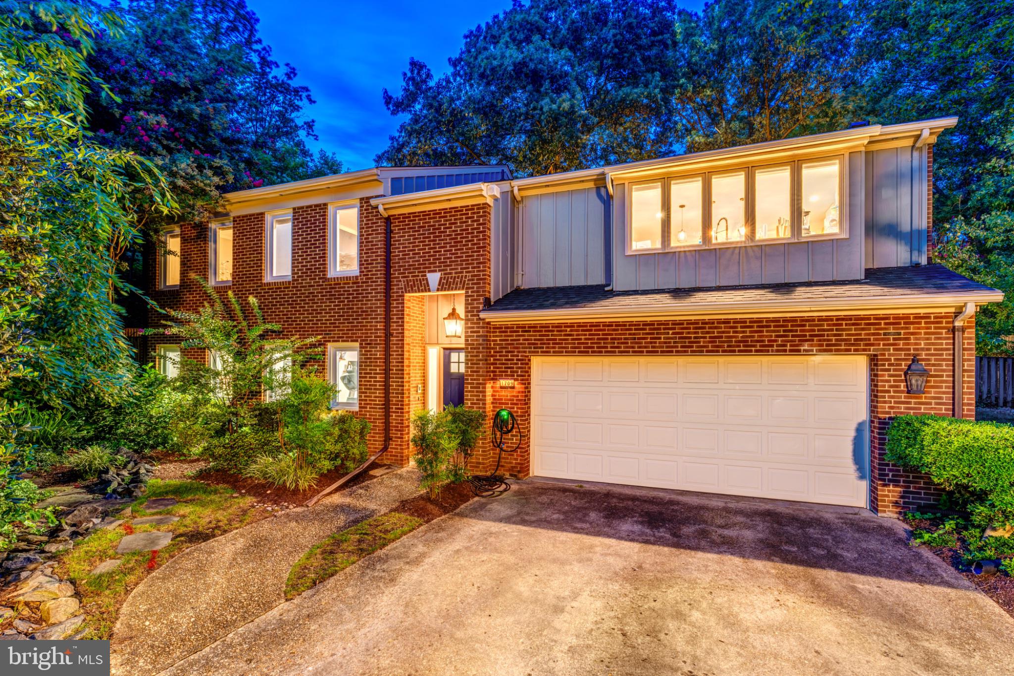 From the moment you turn onto our quiet cul de sac, not a through street, you understand why we always felt we had the best homesite in Maple Hill, perched up above the community and backing to mature trees that give us real privacy along with a gorgeous flat backyard, fully fenced and beautifully landscaped, where we have spent countless evenings on the huge paver patio entertaining friends while the kids run around, plus a two car garage and driveway that has made parking for gatherings so easy. We bought this five bedroom, three full bath brick and Hardie mid-century modern, built by Robinson-Thayer, when every inch of it was outdated, and we renovated it top to bottom with real love and care, putting on a new roof in 2020, replacing the windows in 2022, and installing a new water heater in 2025, all while choosing one consistent timeless color palette throughout so the home would always feel on trend, and you feel that intention the second you walk through the spacious foyer onto wide plank French oak LVP that runs through the whole home, with one panel doors and recessed lighting in every single room. The kitchen, fully remodeled in 2021, is where we spent most of our time, with a huge island with seating, forty two inch white shaker cabinets, quartz counters, a cooktop, built in oven, range hood, stainless appliances, French door fridge, built in microwave, and a deep farmhouse apron sink, sitting beneath a wall of windows that frames the most beautiful view in the community and opens right into a family room with soaring ceilings, a fireplace flanked by built in bookcases and wrapped in shiplap, and light pouring in through the slider doors, all on real hardwood floors that continue through the generously sized main level bedrooms, including a primary suite with a bath we completely renovated in 2024, featuring a freestanding soaking tub, a seamless glass shower, and a dual sink vanity, plus a huge walk in closet with its own organization system and a secondary bath finished with the same on trend tile, shiplap, vanity, and lighting. Hardwood stairs carry you down to a lower level we most recently finished as a media room, with a wood burning fireplace surrounded in brick, a bar area with a beverage fridge and white shaker cabinetry, and a setup ready for a projector screen for movie nights with popcorn, along with two more bedrooms we used as a home gym and a guest suite, a third full bath with that same timeless palette, and a laundry and pantry area with more storage than we ever filled, giving you real flexibility to work from home on either level. What we will miss most has nothing to do with the house itself, it is the neighbors who came to our wedding and celebrated our son's first birthday with us, who still gather in the circle out front to ride bikes and draw with chalk, the walks with our dog through our back gate into Chinquapin Park and the trails leading to the Rec Center, tennis and basketball courts, and community gardens, and the weekend trips through that same gate to Fairlington for coffee at St Elmo's outdoor window, Ramparts, and Harvest, all just minutes from Old Town Alexandria, Shirlington, the GW Parkway, King Street Metro, Pentagon City, Amazon's headquarters, and 495, with the HOA even handling the yard work, trash, exterior painting, and snow removal so all that is left for you to do here is live.
