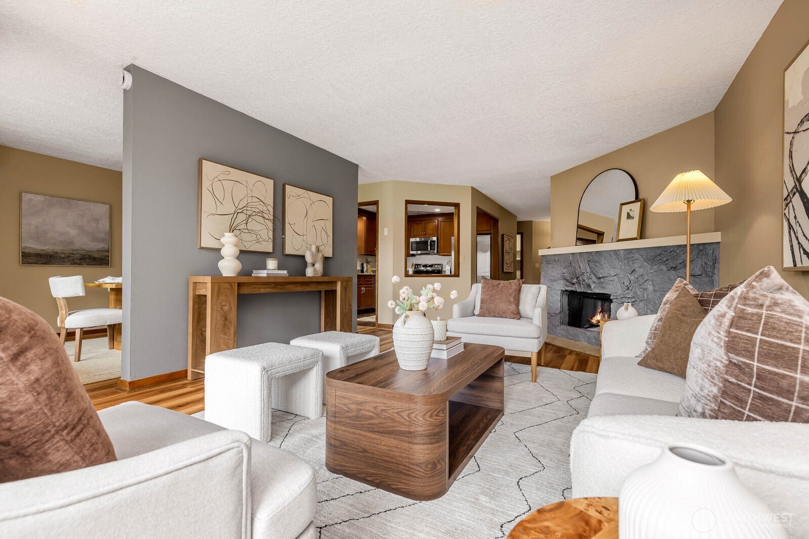 Enjoy the best of Edmonds living in this spacious 2-bedroom, 2-bath condo ideally located just moments from the charm of Downtown Edmonds on the desirable west side of 5th Avenue. Designed for comfort and convenience, this home features a bright, open layout with an expansive living room centered around a cozy fireplace and a formal dining area perfect for entertaining. The oversized kitchen shines with all new appliances, abundant cabinetry, and generous workspace. New laminate flooring extends through most of the home, while mini-split systems in both bedrooms and the dining room provide efficient year-round comfort and cooling. Step outside to the private west-facing patio, a peaceful setting to relax and enjoy the afternoon sun. The generous primary suite includes a private bath with dual sinks, and both bedrooms offer exceptional space. A walk-in laundry room, pantry, and abundant storage throughout add everyday functionality. Secure building amenities include elevator access, fitness center, rec room, dedicated parking, and an additional storage unit. HOA dues cover water, sewer, and garbage, making this an exceptional opportunity to enjoy low-maintenance living in one of Edmonds' most desirable locations.