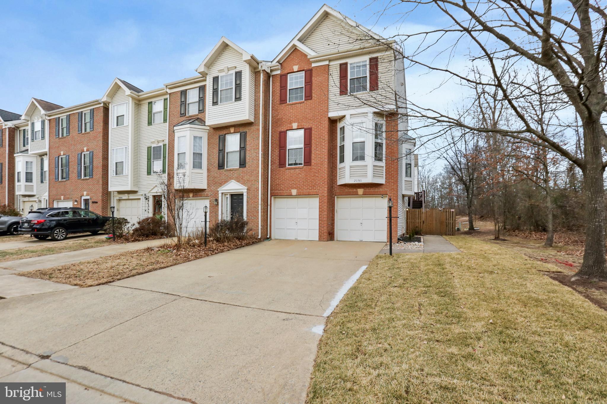 Welcome to this well-maintained end unit townhome in the sought-after Ashburn Farm community. This move-in ready home offers over 2,000 square feet of thoughtfully designed living space with fresh paint throughout and brand new carpeting on the lower and upper levels (2026).The main level welcomes you with gleaming hardwood floors that flow through the open living room, where two bay windows flood the space with natural light. The updated kitchen features crisp white cabinets, granite countertops, and stainless steel appliances (all replaced within the last two years, including an induction stove/oven in 2024, dishwasher in 2024, and refrigerator in 2025). Adjacent to the kitchen, the spacious dining area is bathed in sunlight from numerous windows and provides access to an expansive deck through sliding glass doors—perfect for indoor-outdoor entertaining. The deck includes stairs leading down to the private fully-fenced backyard.Upstairs, the primary suite impresses with soaring vaulted ceilings, a generous walk-in closet, and a luxurious en suite bathroom featuring a dual vanity, soaking tub, and separate shower. Two additional bedrooms, another full bathroom, and a convenient upper-level laundry room complete this floor.The walk-out lower level offers endless possibilities with a large recreation room that can serve as a home gym, office, second living space, or guest area. Step outside to the lower-level patio—ideal for relaxing or entertaining.As an end unit, this home benefits from additional natural light and a surprisingly long driveway leading to the two-car front load garage. Recent major system updates provide peace of mind: new roof and water heater (2023), HVAC (2022), fence (2024), and outdoor aluminum trim (2025).Ashburn Farm residents enjoy access to exceptional community amenities including pools, tennis courts, sports fields, playgrounds, and a pavilion. The location offers unbeatable convenience—positioned between Route 7 and the Greenway for easy commuting, less than 10 miles to Dulles International Airport, and approximately 4 miles to the Ashburn Metro station.This turnkey home combines modern updates, flexible living spaces, and a prime location. Welcome Home! (Please note that all furniture in photos is virtually staged)