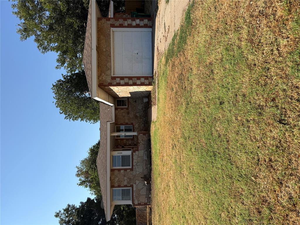 Great starter home or investment property.  New roof in October 2026.  New garage door.  Newer windows in most of the rooms. Beautiful front doors that are only a year old.  Home features 2 living room, 1 which includes a fireplace and a large inground storm shelter.  Kitchen features solid surface countertops and shelves for extra storage.  Wood floors thru out the home.  Home is light and bright.  Listing Realtor has an interest in the property.