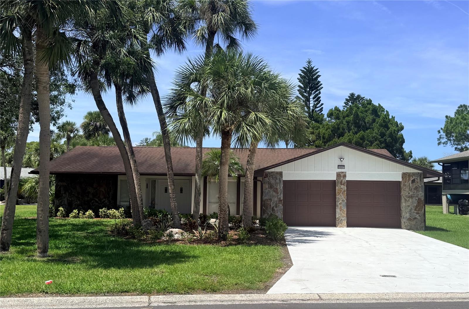 MOVE-IN READY POOL HOME! Welcome to 5507 Nimitz Road, where modern updates, generous living spaces, and the Florida lifestyle come together beautifully. This stunning 3-bedroom, 2-bath home offers 2,406 sq. ft. of thoughtfully updated living space with a bright, open layout designed for entertaining and everyday comfort.From the moment you step inside, you'll notice the fresh, contemporary feel, with beautiful flooring throughout, recessed lighting, modern fixtures, and an abundance of natural light. The show-stopping kitchen anchors the main living area with shaker-style cabinetry, stainless steel appliances, dramatic waterfall countertops, abundant storage, and an oversized peninsula offering plenty of space to gather, dine, and entertain.The beautifully renovated bathrooms feature frameless glass showers, floor-to-ceiling tile, contemporary vanities, and stylish fixtures. Multiple spacious living areas provide flexibility for entertaining, relaxing, working from home, or hosting guests.Step outside and enjoy your own private Florida retreat featuring a screened-in swimming pool and covered outdoor living area—perfect for sunny afternoons, outdoor dining, or entertaining year-round. Mature landscaping surrounds the property, while the spacious 2-car garage and generous lot add even more convenience.Ideally located in New Port Richey with convenient access to shopping, dining, parks, recreation, and the Gulf Coast. Beautifully updated, spacious, and ready to enjoy from day one—schedule your private showing.