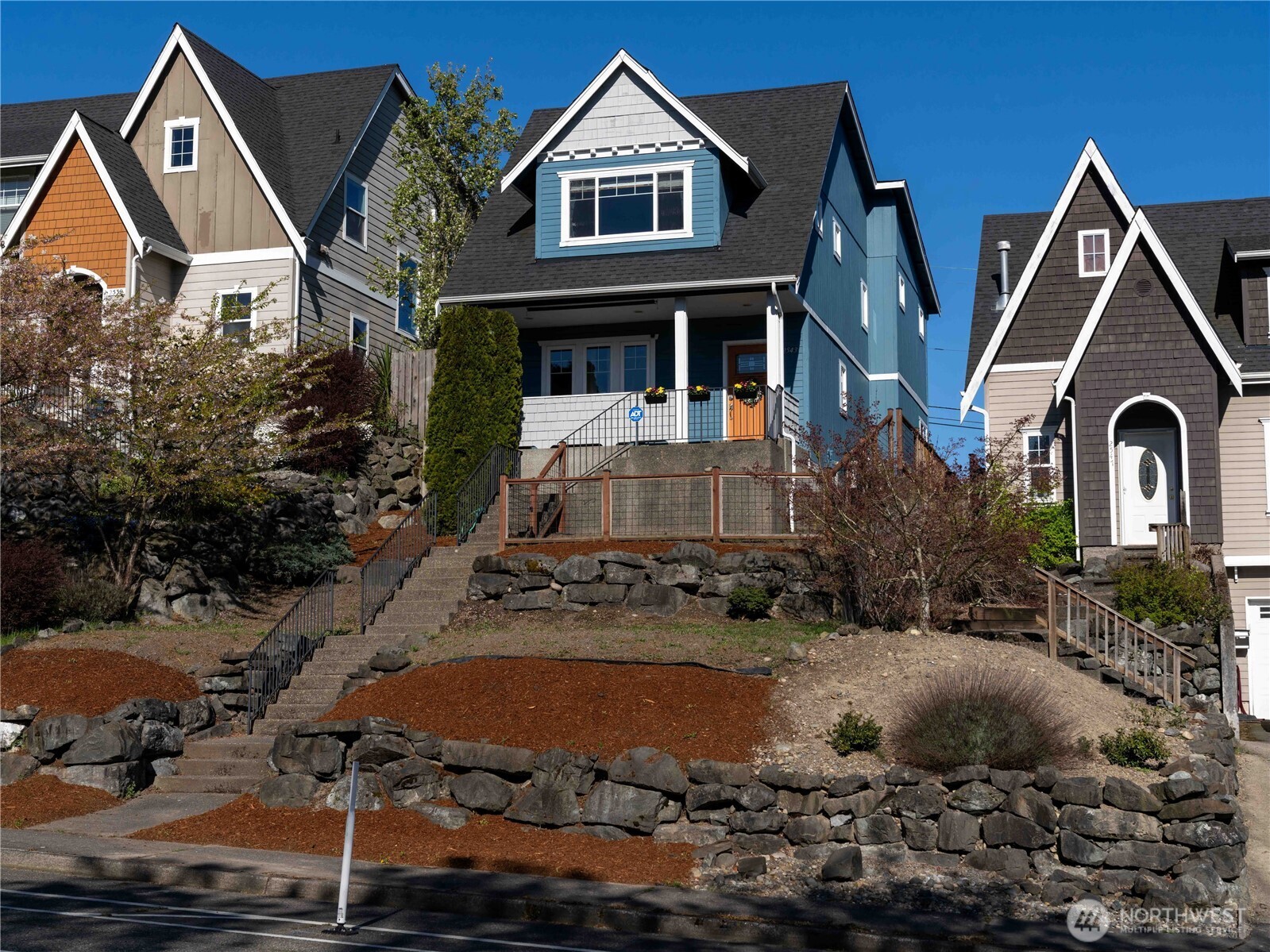 Beautifully updated Craftsman-style home showcasing stunning views of Mount Rainier and thoughtfully designed for both comfort and versatility. The inviting covered front porch overlooks a freshly landscaped, terraced front yard—perfect for enjoying morning coffee or evening sunsets.  Inside, the main level features newer hardwood flooring (2024), an open-concept layout, and seamless flow between the living, dining, and kitchen spaces. The kitchen offers an updated pantry and connects effortlessly to the dining area and cozy living room with a gas fireplace. A convenient main-floor bedroom and half bath provide flexibility for guests, office space, or multi-generational living.  Upstairs, you’ll find two spacious primary suites, each with its own en-suite bath and walk-in closet—an ideal setup for privacy and comfort. A dedicated laundry space adds everyday convenience.  Additional highlights include a fully fenced yard, ADT security system (2024), rear entry access, a detached one-car garage, and extra parking via a quiet dead-end alley.  Whether you’re looking for a primary residence, low-maintenance investment property, or short-term rental opportunity, this home offers exceptional flexibility. Ideally located near hospitals, popular restaurants, and local breweries, with easy access to downtown Tacoma and light rail, this is Pacific Northwest living at its best.